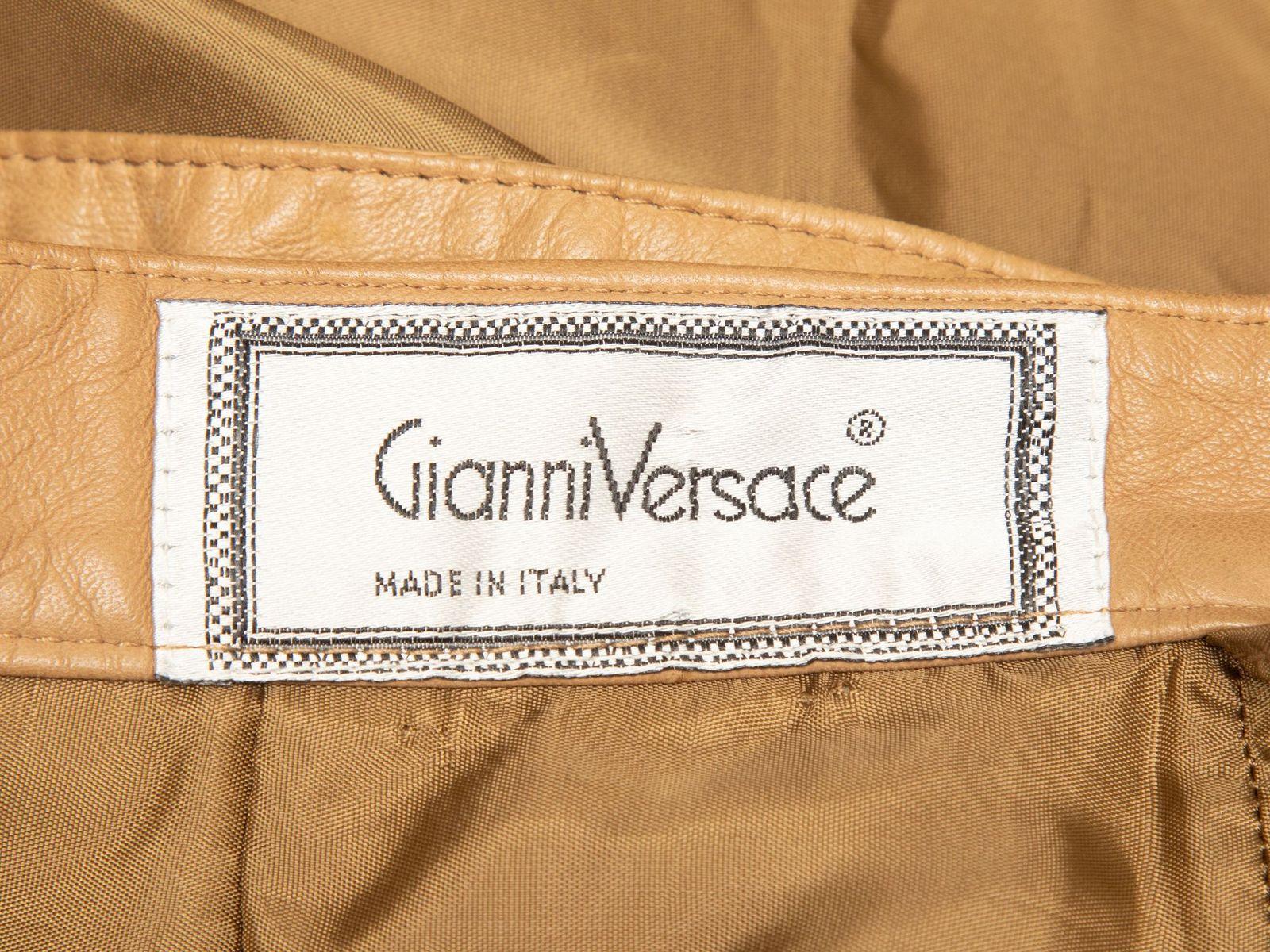 Product Details: Vintage tan leather wrap skirt by Gianni Versace. Button closure at waist. 24