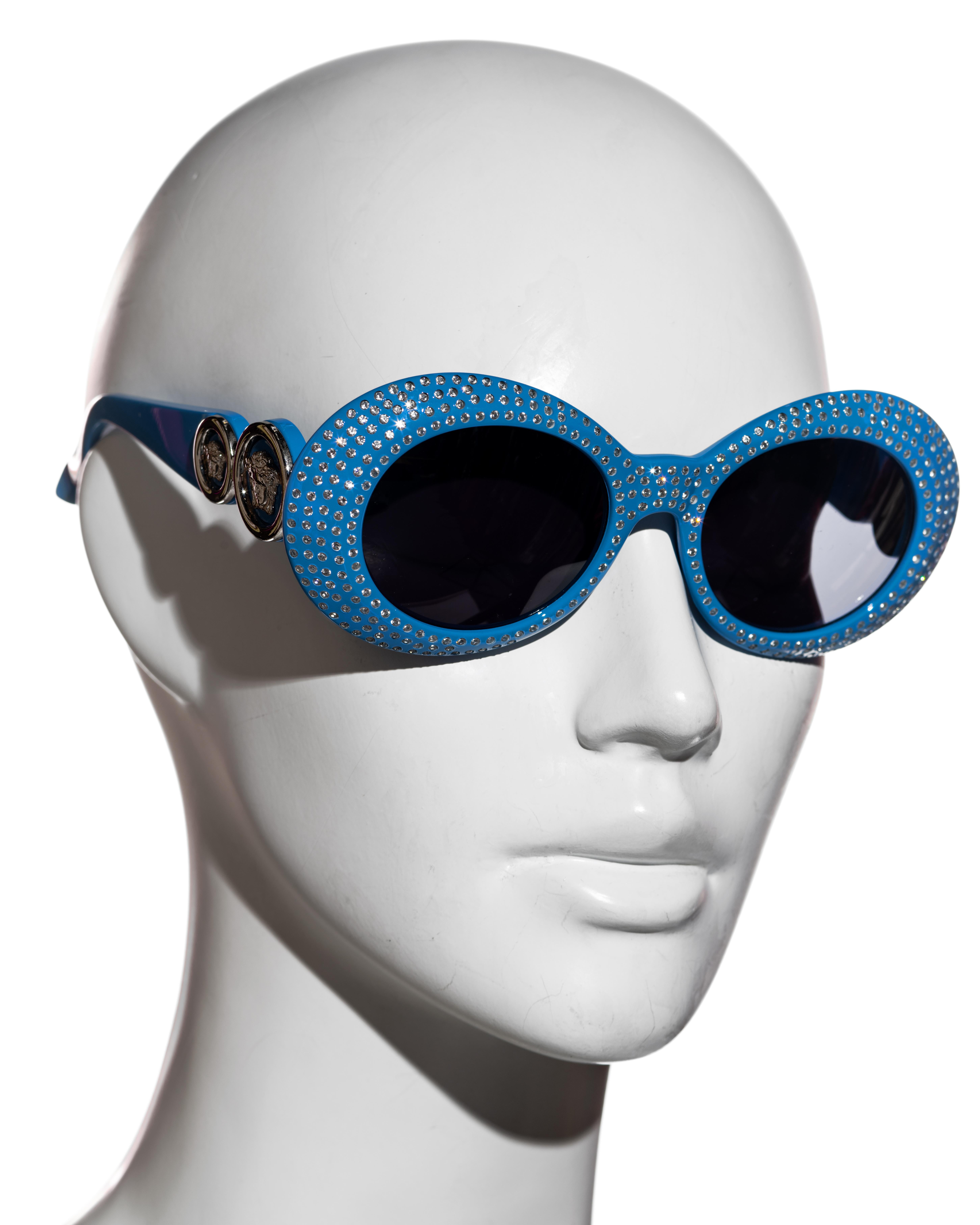 ▪ Gianni Versace unisex blue rhinestone sunglasses 
▪ Large round frames
▪ Dark lenses 
▪ Silver Medusa detail on the temples 
▪ Fall-Winter 1996