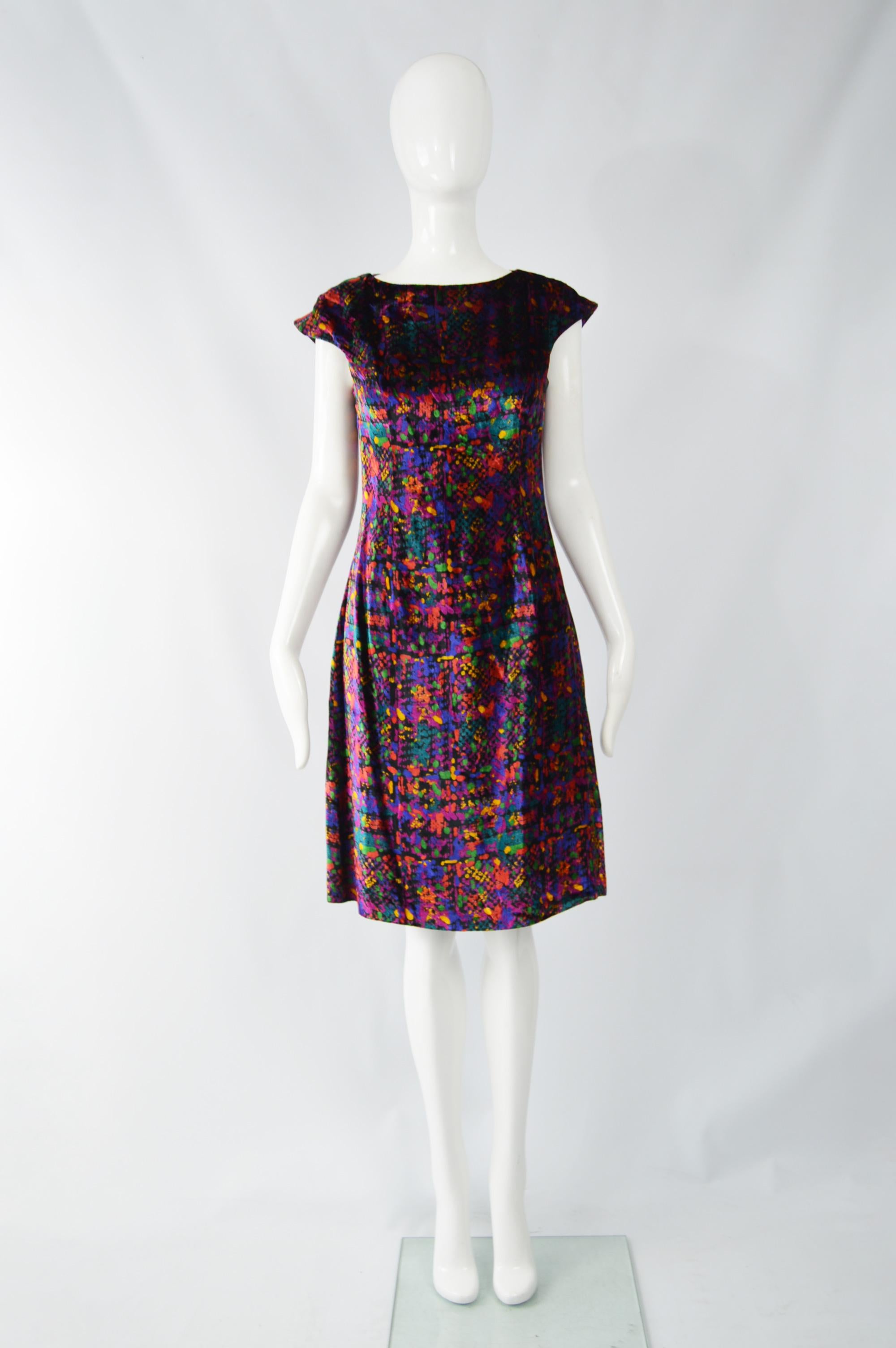 A fabulous vintage womens cocktail / party dress from the 90s by luxury Italian fashion house, Versace for the Versus line. In a sumputuous purple velvet with a multicolored, optical illusion print throughout. 

Size: Marked IT42 which is roughly a