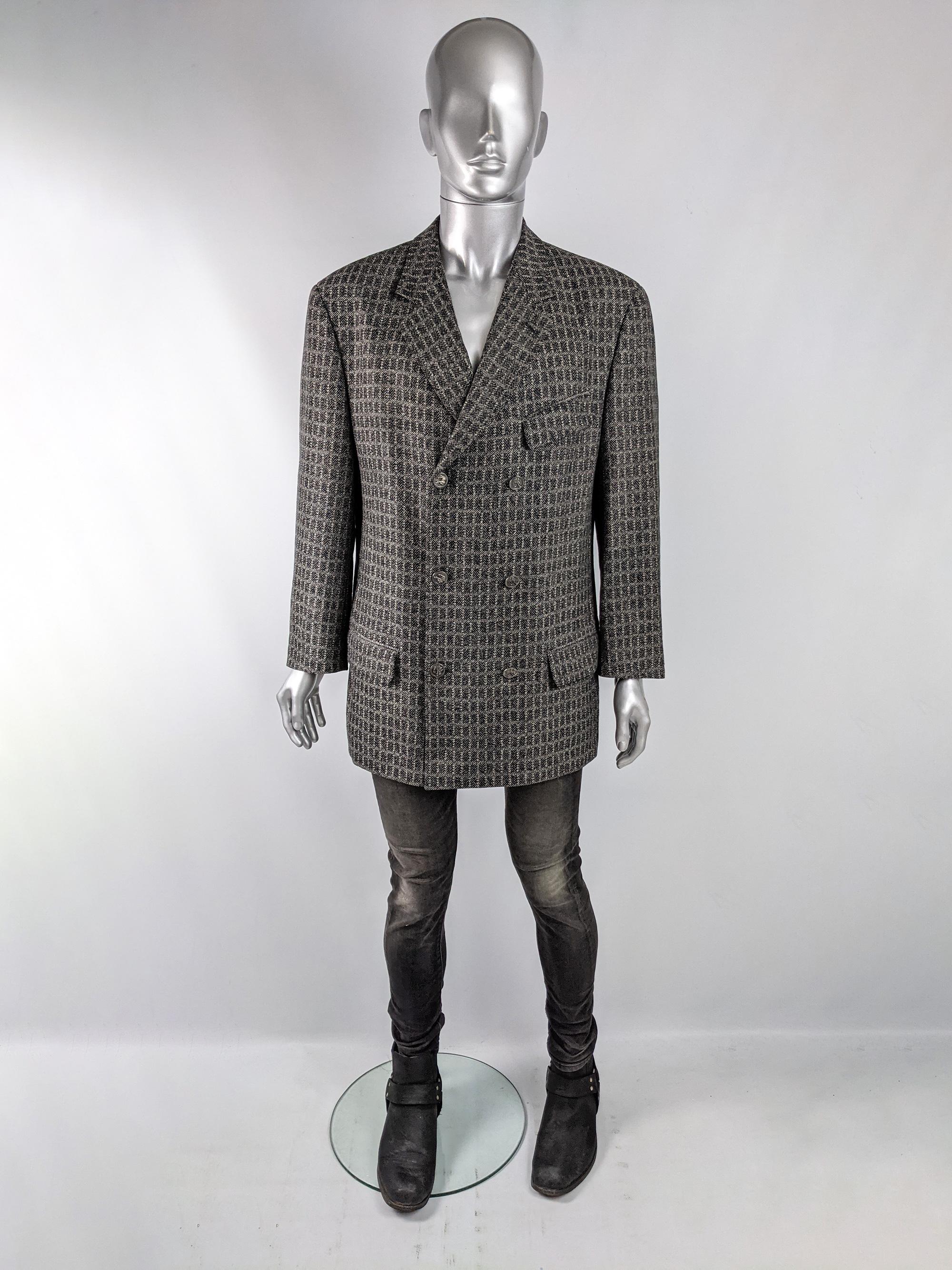 A stylish vintage mens Versus by Gianni Versace blazer / sport coat from the 90s in a black and grey checked wool and mohair fabric with subtle multicolored flecks throughout. It is double breasted with the Versus logo moulded on the buttons.