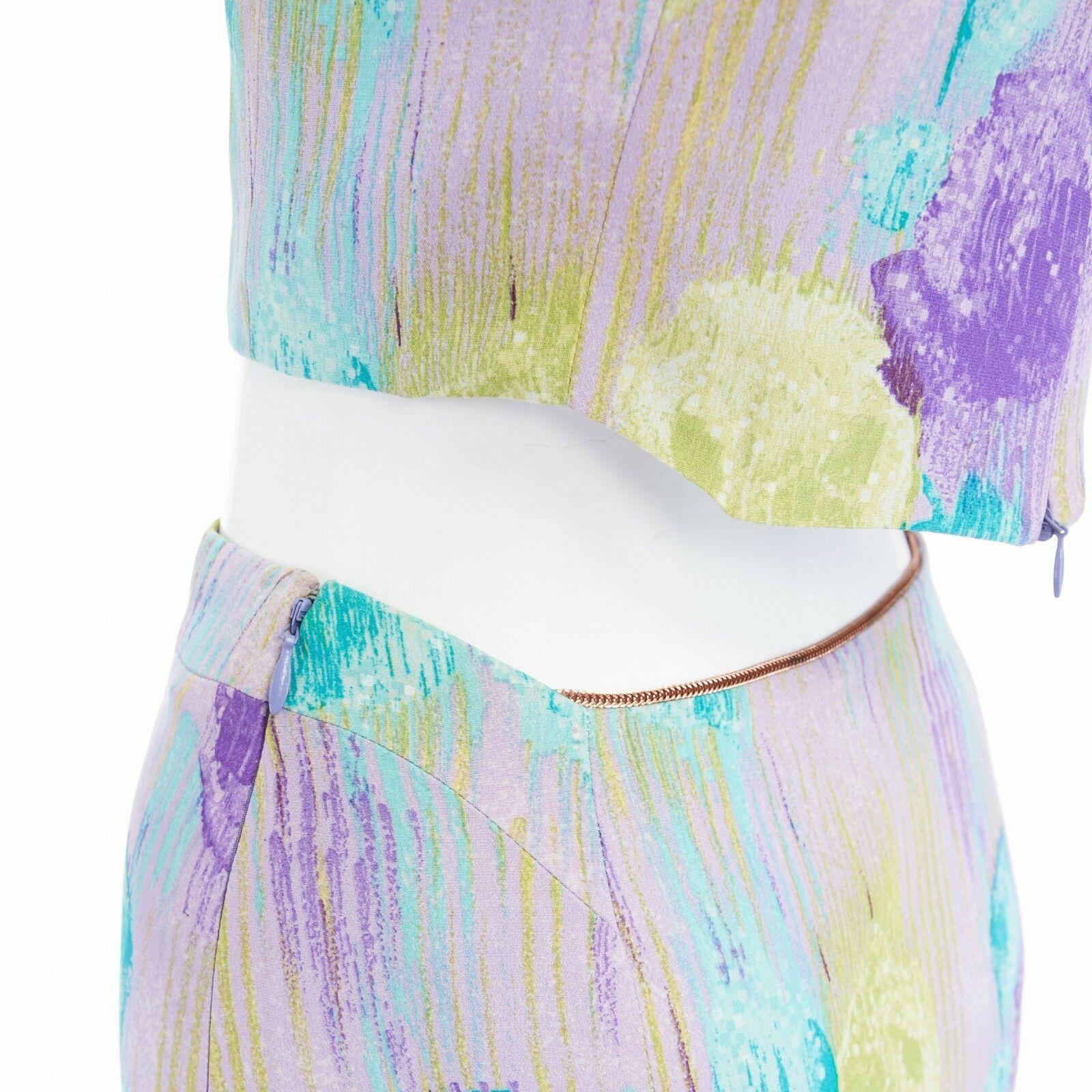 GIANNI VERSACE Vintage 1990s abstract floral print chain trim crop top skirt XS
GIANNI VERSACE
FROM THE 90'S
100% silk . 
Lilac purple base . 
Abstract floral, dripped paint effect purple, lime green and teal blue print throughout . Angular wide