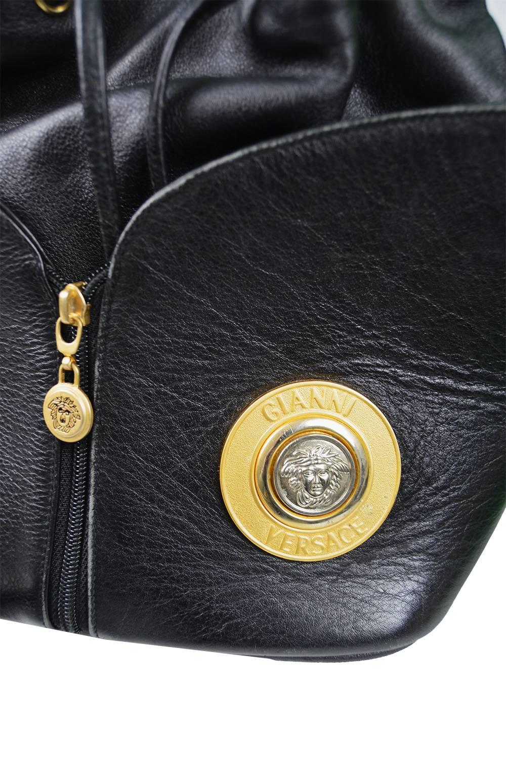 Gianni Versace Vintage 1990s Black Leather Gold & Silver Drawstring Shoulder Bag

Size: Width - 10” / 25cm
Height - 10” / 25cm
Depth - 6” / 15cm
Strap Drop - 17” / 43cm 

Condition: Excellent Vintage Condition - Light signs of wear commensurate with
