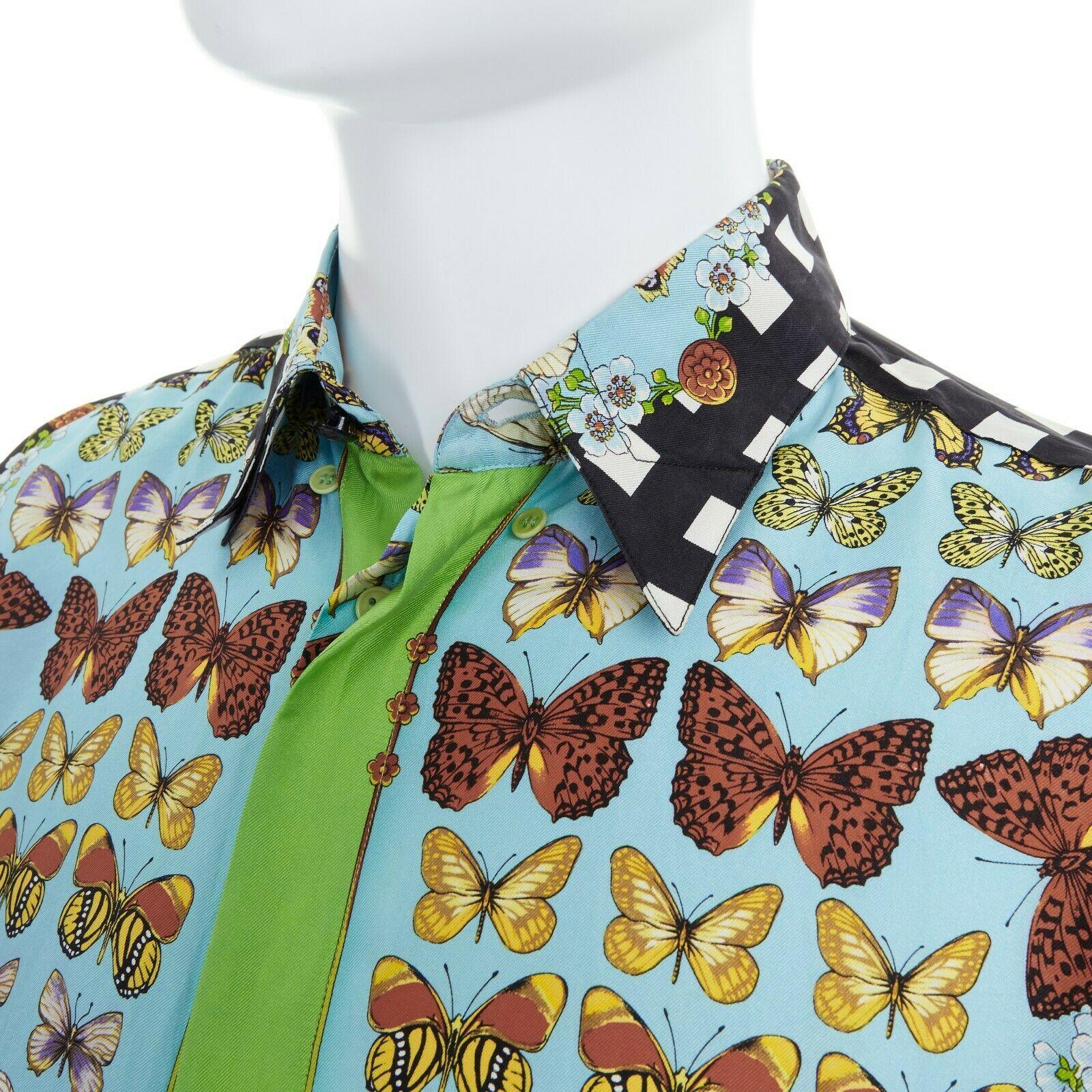 GIANNI VERSACE Vintage 1995 100% silk blue butterfly checkered back shirt S

GIANNI VERSACE VINTAGE
FROM THE 1995 COLLECTION
100% silk. Light blue base with multicolor butterfly print. Lime green placket. Black-white checkered sleeves and back.