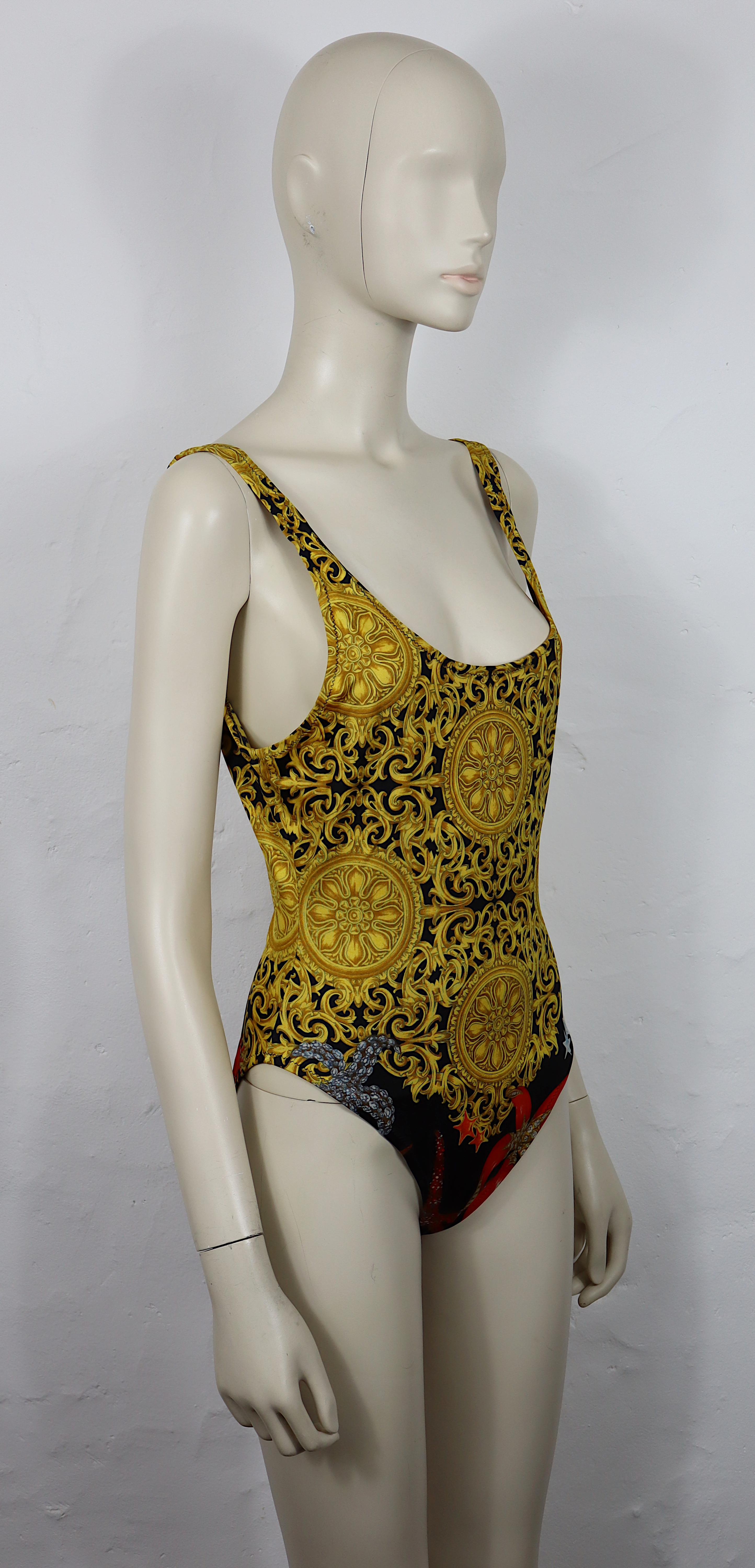 GIANNI VERSACE vintage one-piece backless swimsuit featuring a GIANNI VERSACE signature Barroco print with seashells.

Label reads VERSACE MARE.
Made in Italy.

Size label reads : 44.
Please refer to measurements. 

Composition label reads : 78 %