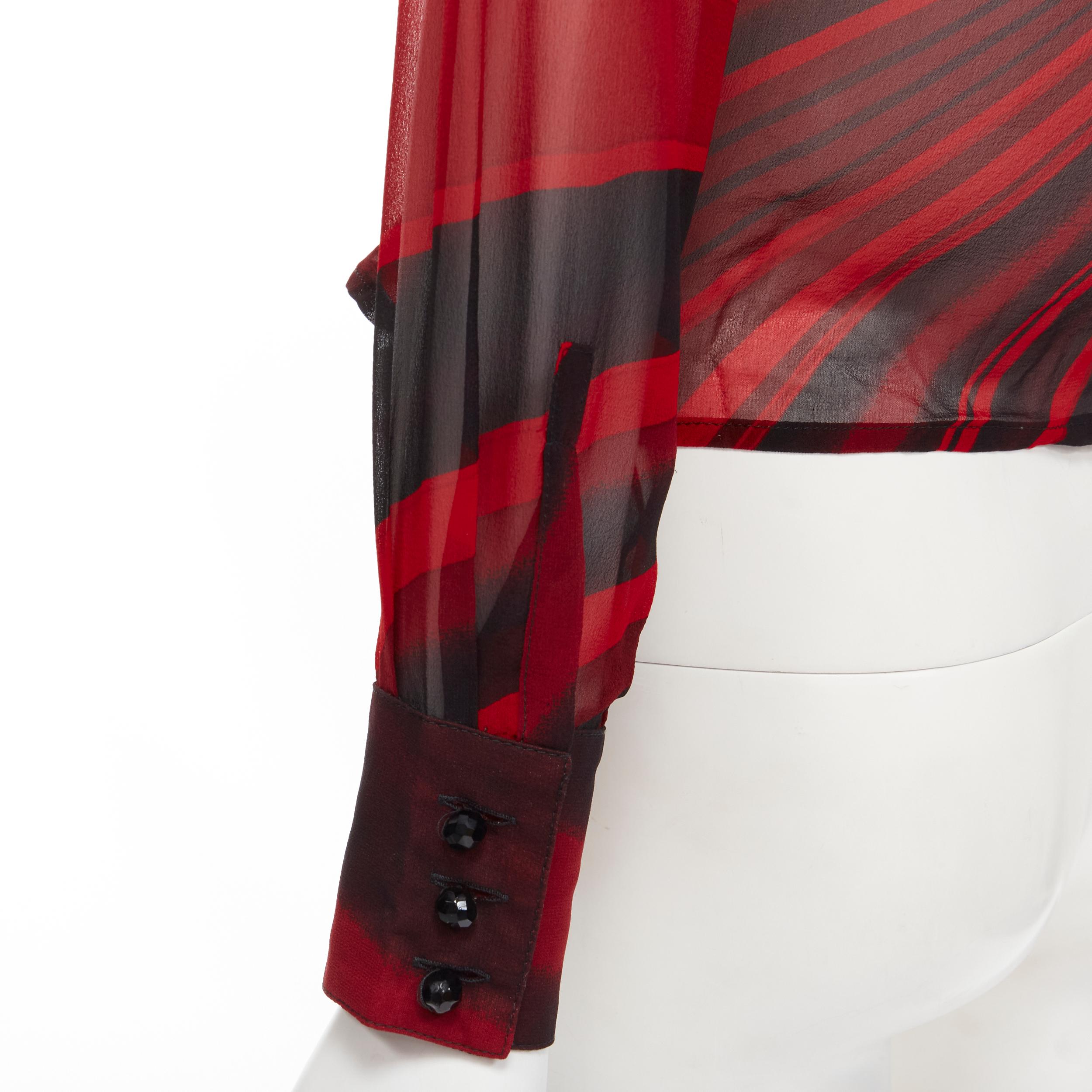 GIANNI VERSACE Vintage black red swirl print crossover wrap top IT42 M 
Reference: GIYG/A00193 
Brand: Gianni Versace 
Collection: Fall Winter 2000 
Material: Silk 
Color: Red 
Pattern: Swirl 
Closure: Button 
Extra Detail: Wrap front with concealed