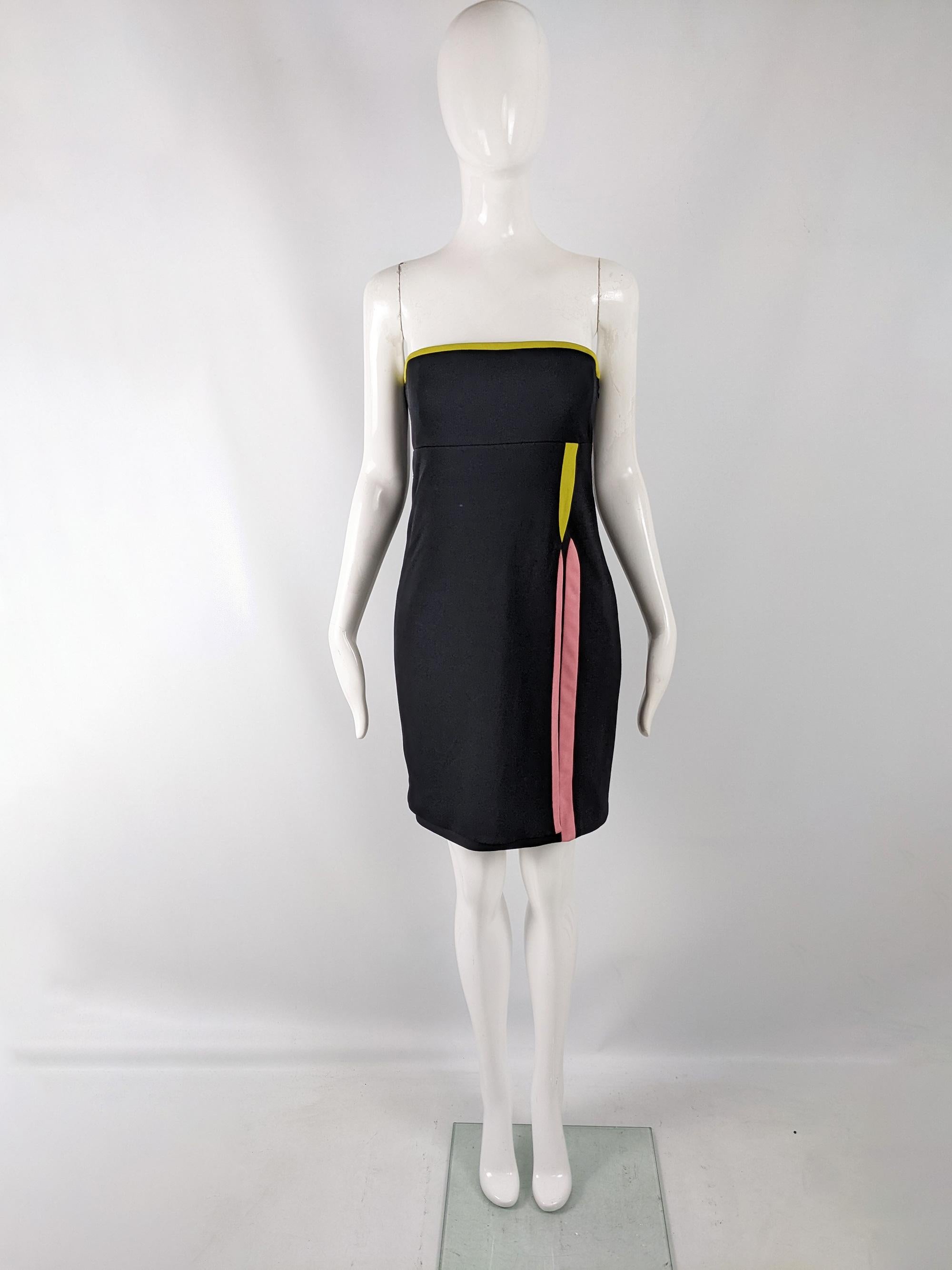 A fabulous and rare vintage womens party dress from the 1997 Fall collection by Gianni Versace (as seen on the runway). In a black wool, rayon and silk blend fabric with a strapless fit, built in corset in the bodice and lime green and pink