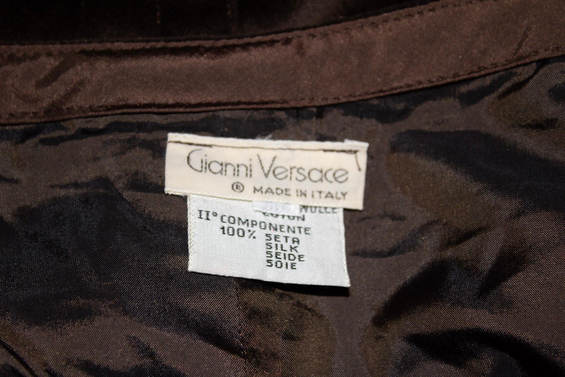 A fun vintage skirt for Fall by Gianni Versace.  The skirt has a tie wrap over front and a side zip opening. It is unlined, and has a 3 1/2 '' slit.
Measurements: Waist 32'', length 22''