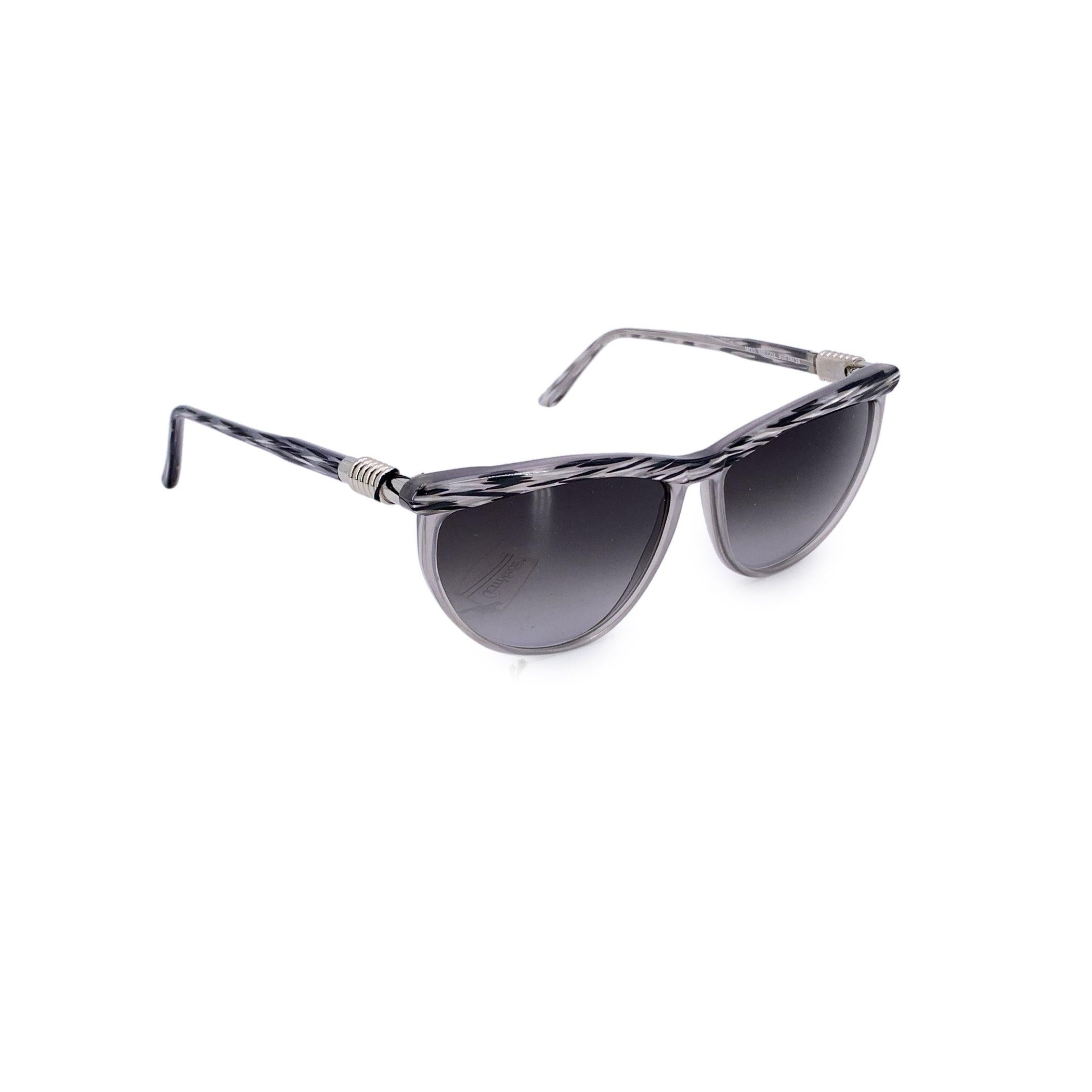 These vintage Gianni Versace sunglasses, model 488 col. 930- 56/15 140mm, are a bold expression of classic '90s Italian design. Crafted in a sleek grey acetate rcat eye frame, they exude understated luxury while still capturing that unmistakable