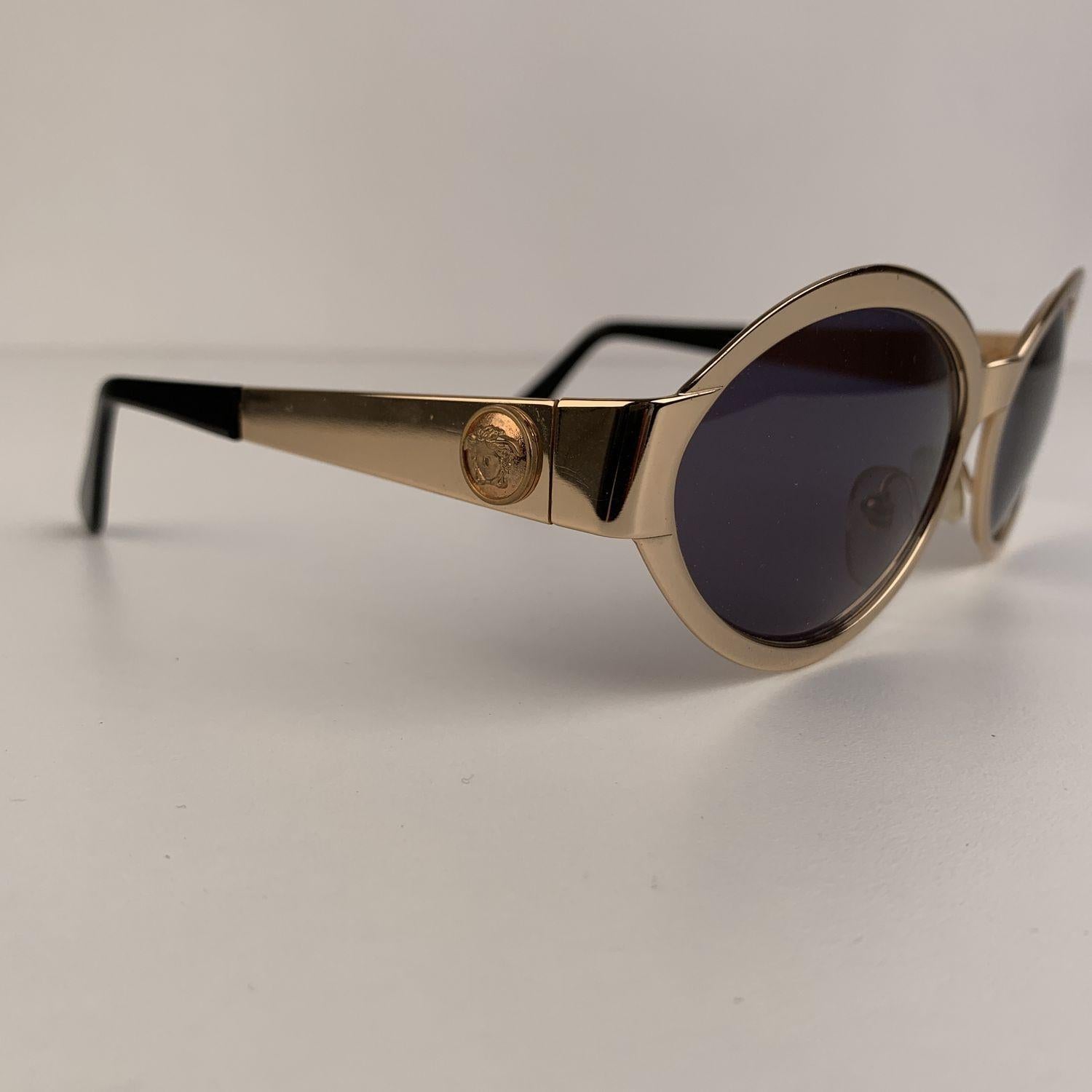 Beautiful vintage Gianni Versace Mod S 97, Col. 030 sunglasses. Gold metal oval frame with gray original lenses. Gold metal Medusa heads on temples. Adjustable nose pads . Made in Italy. Details MATERIAL: Metal COLOR: Gold MODEL: S97 GENDER: Unisex