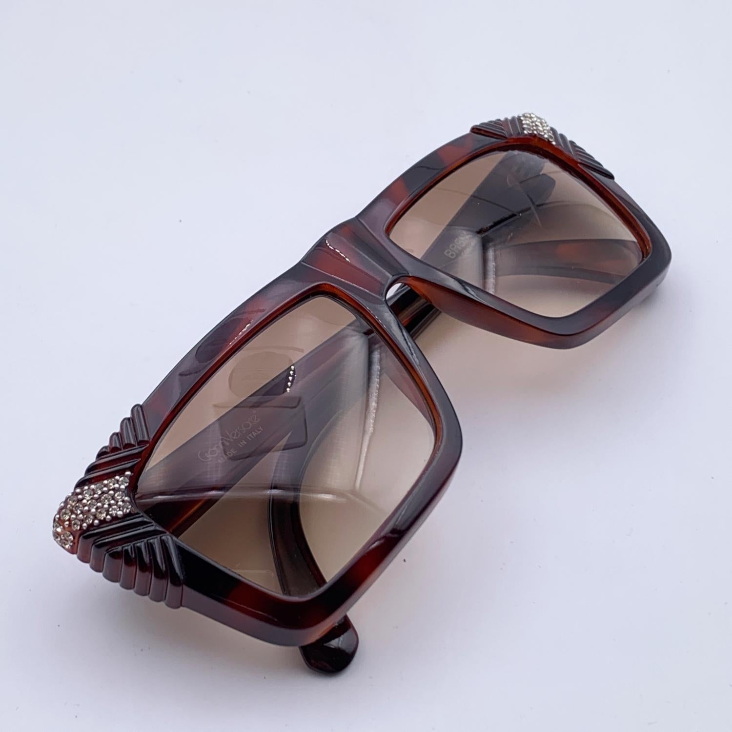 Brown, rectangular-shaped vintage sunglasses Mod. Basix 812 Col.688 by Gianni Versace. Iconic 90s sunglasses with rhinestones detailing on corners. Made in Italy. Original 100% Total UVA UVB protection original gradient brown