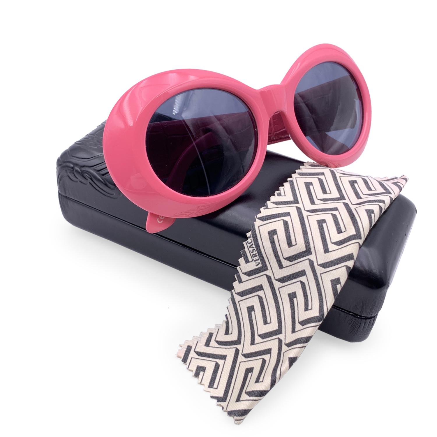 Beautiful vintage Versace Mod 418/P Col. 930 sunglasses in pink color. Distinctive thick rounded front frame. Pink leather wrapped arms with croc embossed leather. Gold metal MEDUSA heads on temples. Marked on inner arm 'GIANNI VERSACE - made in