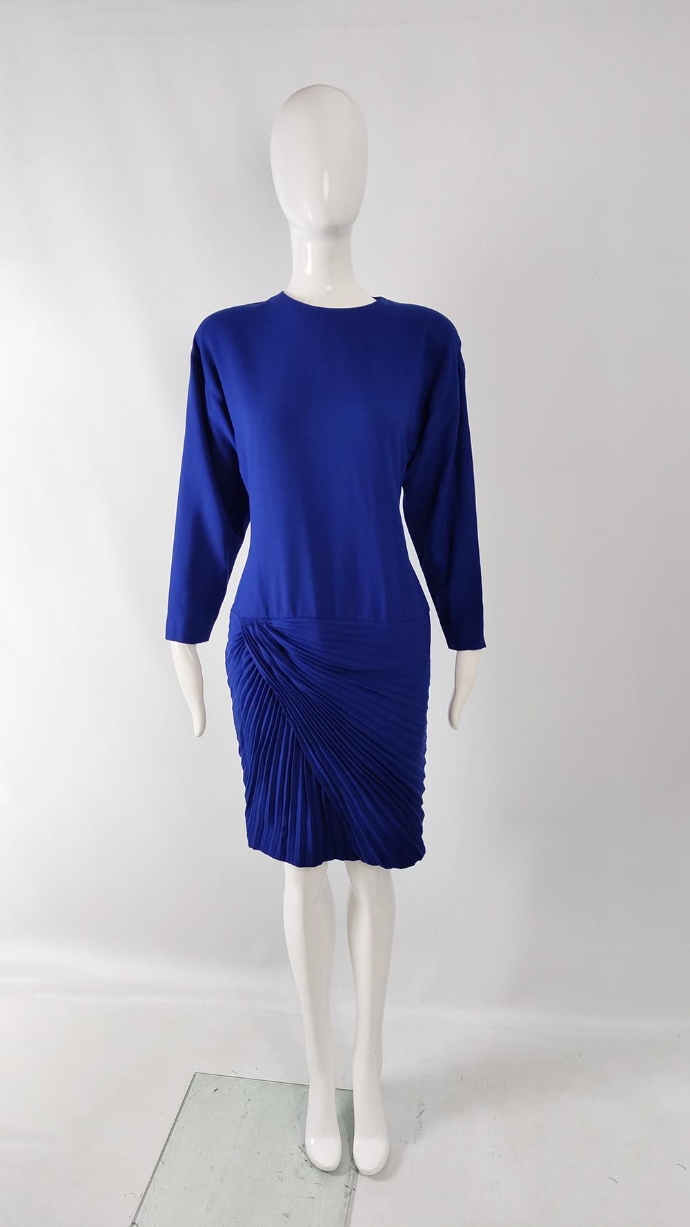 An incredible vintage 1980s womens dress and scarf set from the autumn-winter 1989 collection by luxury Italian fashion designer, Gianni Versace. In a blue wool with long raglan sleeves. The dress has a drop waist design with amazing pleating on the