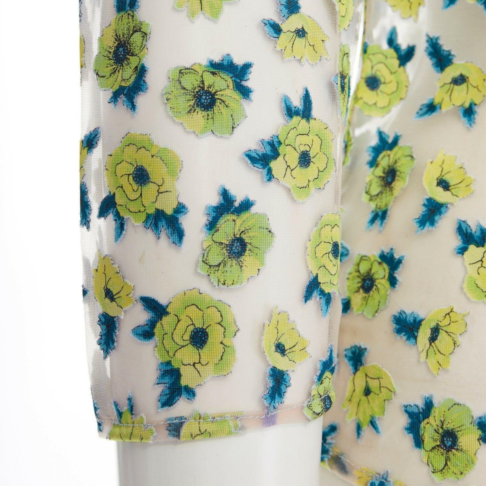 GIANNI VERSACE Vintage SS96 green floral sheer devore cropped sleeve top IT40 S
GIANNI VERSACE VINTAGEFROM THE SPRING SUMMER 1996 COLLECTION
Rayon, nylon. 
Clear sheer base with yellow and teal blue floral devore. 
Rounded neckline. 
3/4 sleeves.