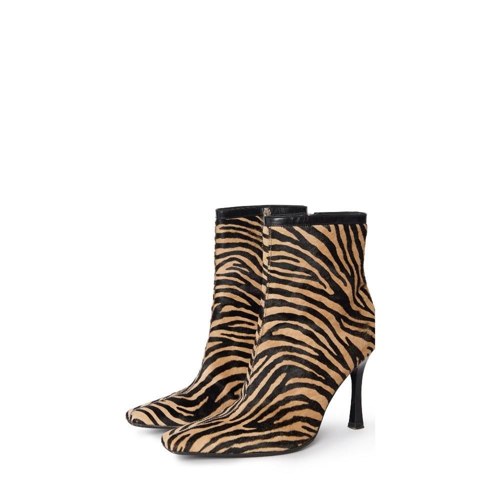 These rare vintage Gianni Versace  boots are a stunning example of the brand's bold and luxurious design ethos.

Crafted in genuine pony hair with a striking zebra print, these boots embody the glamour and confidence synonymous with Versace.