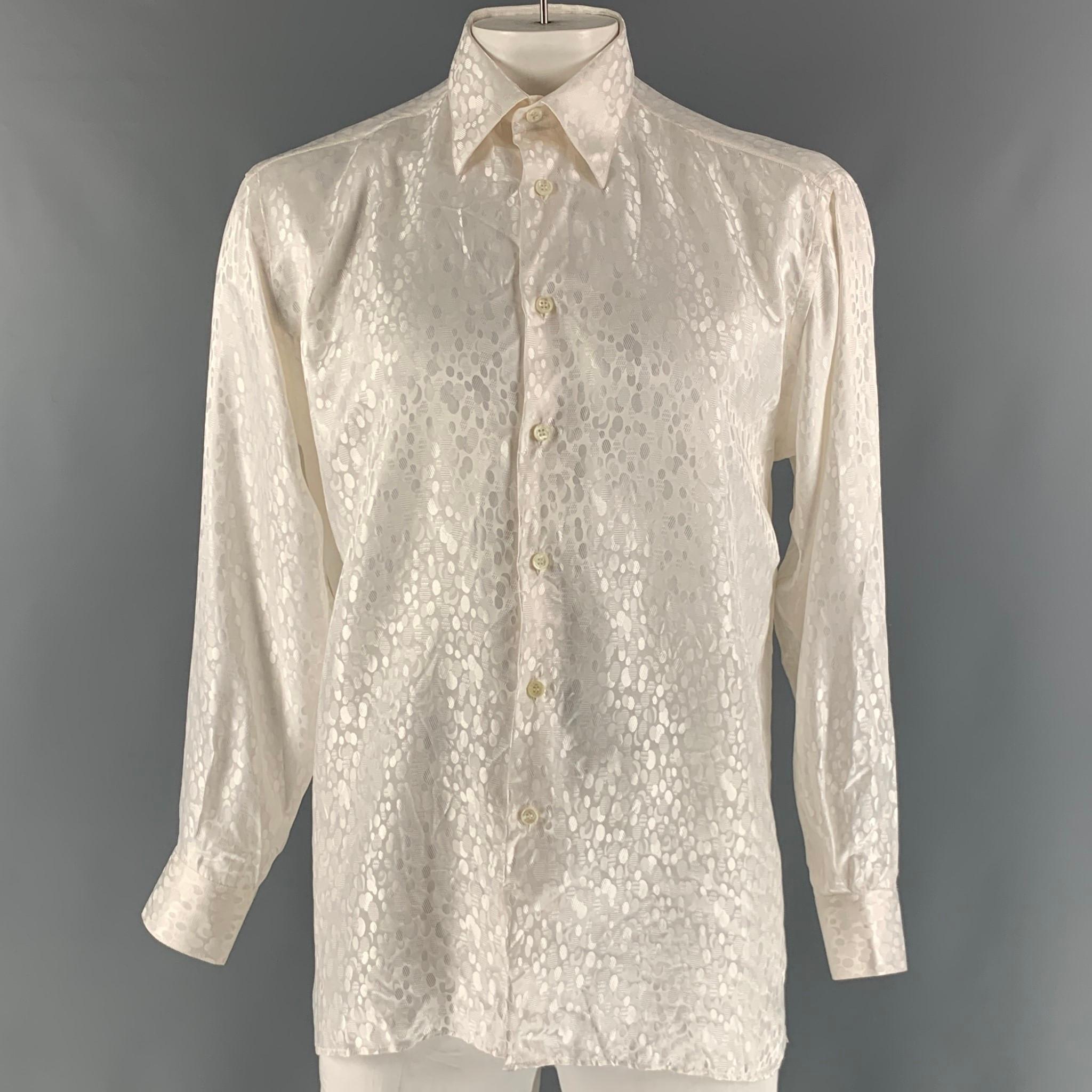 GIANNI VIERA long sleeve shirt comes in a white dots jacquard silk material featuring a classic style, straight collar, and a button up closure. Made in Italy.

Very Good Pre-Owned Condition. Minor sign of wear.
Marked: L

Measurements:

Shoulder: