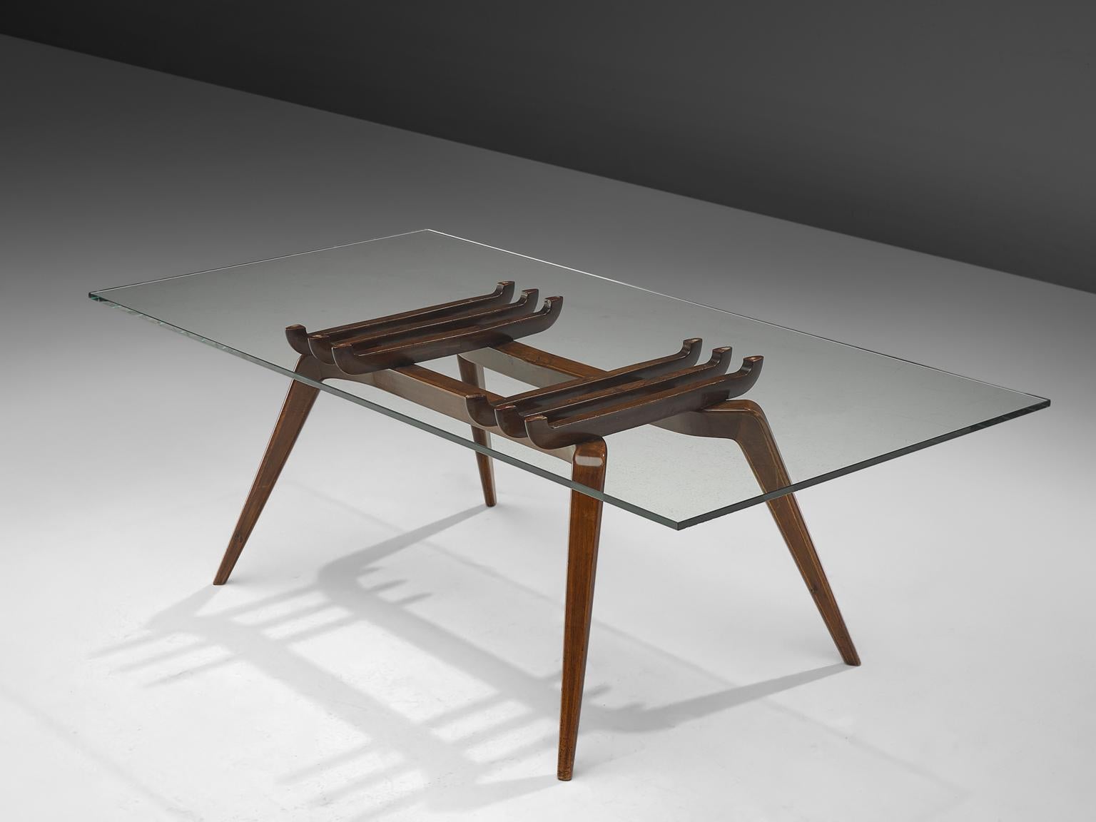 Gianni Vigorelli, dining table, glass and walnut, Italy, 1950s.

This sculptural table is designed by Italian designer Gianni Vigorelli. The table is simply called: Tavolo da pranzo (dining table). 
The beautiful, elegant frame, features tapered