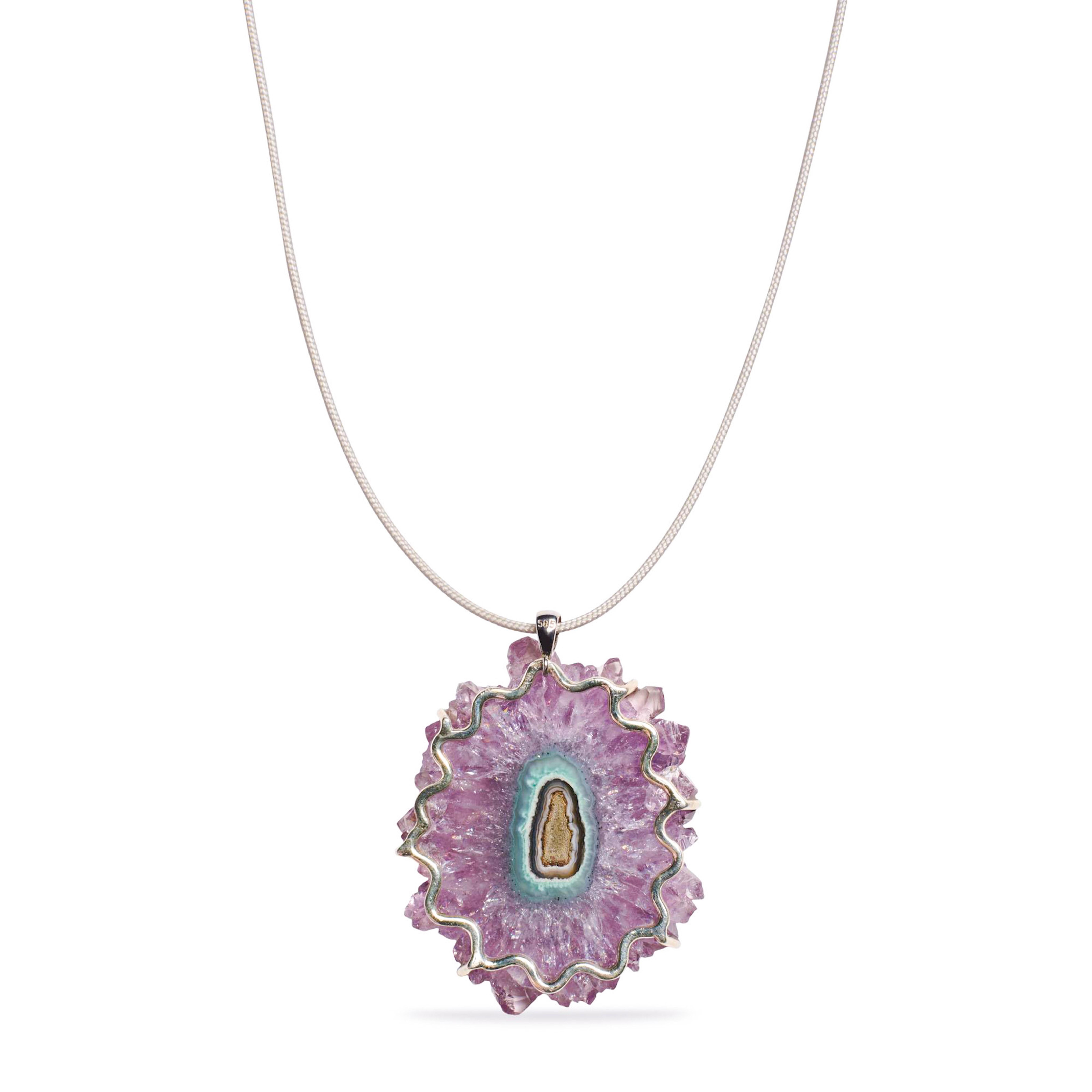 A sparkling purple and green amethyst stalctite slice from Artigas, Uruguay.
The stalactite slice dates back from the 70's where it has been mined in Uriguay. It is a true showstopper, a one of a kind. This large size, color combination and clarity