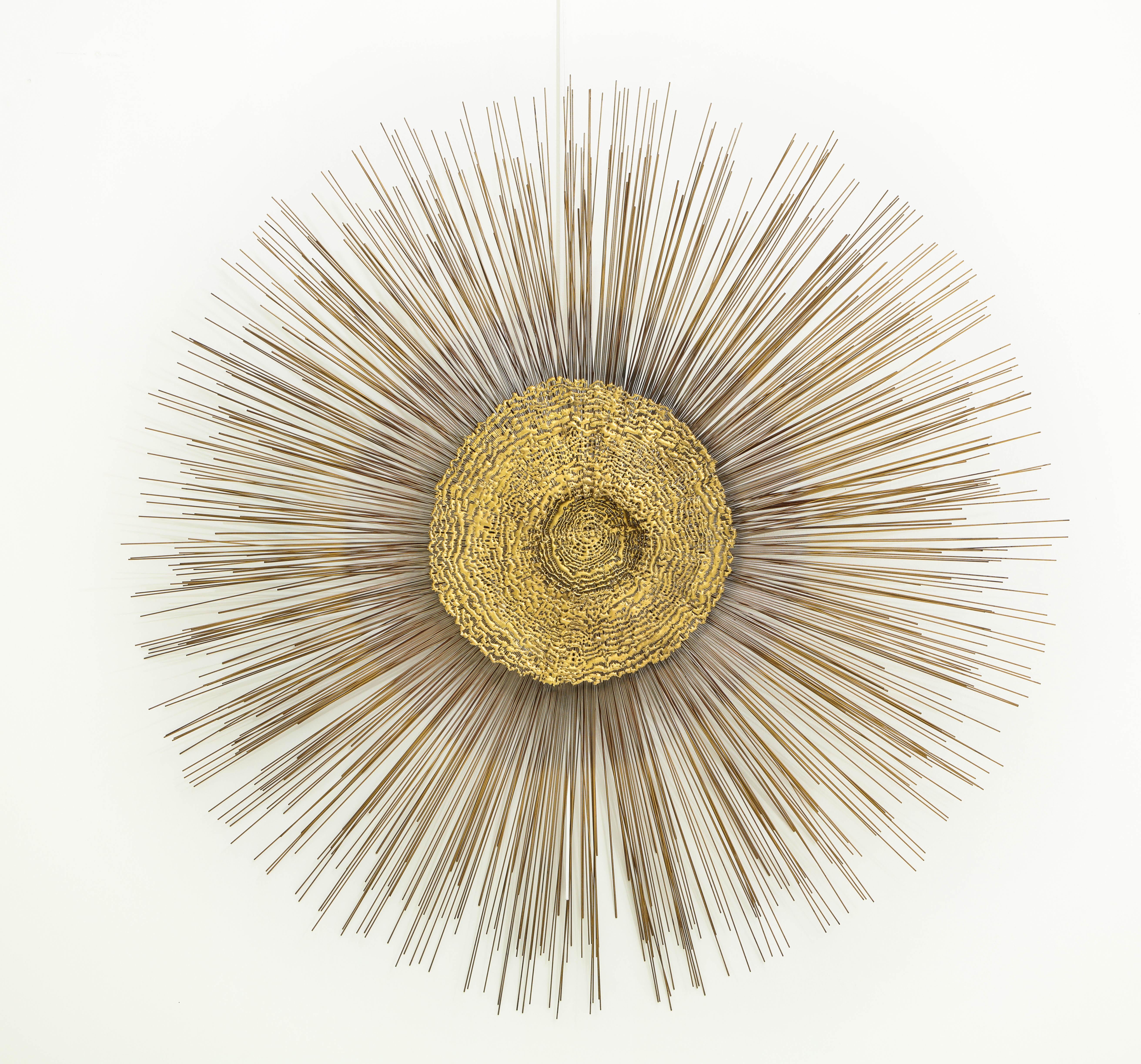 Giant 1970s Brutalist wall sculpture by Curtis Jere.
The sculpture features a circular abstract design on top of radiating brass rods of varying lengths.