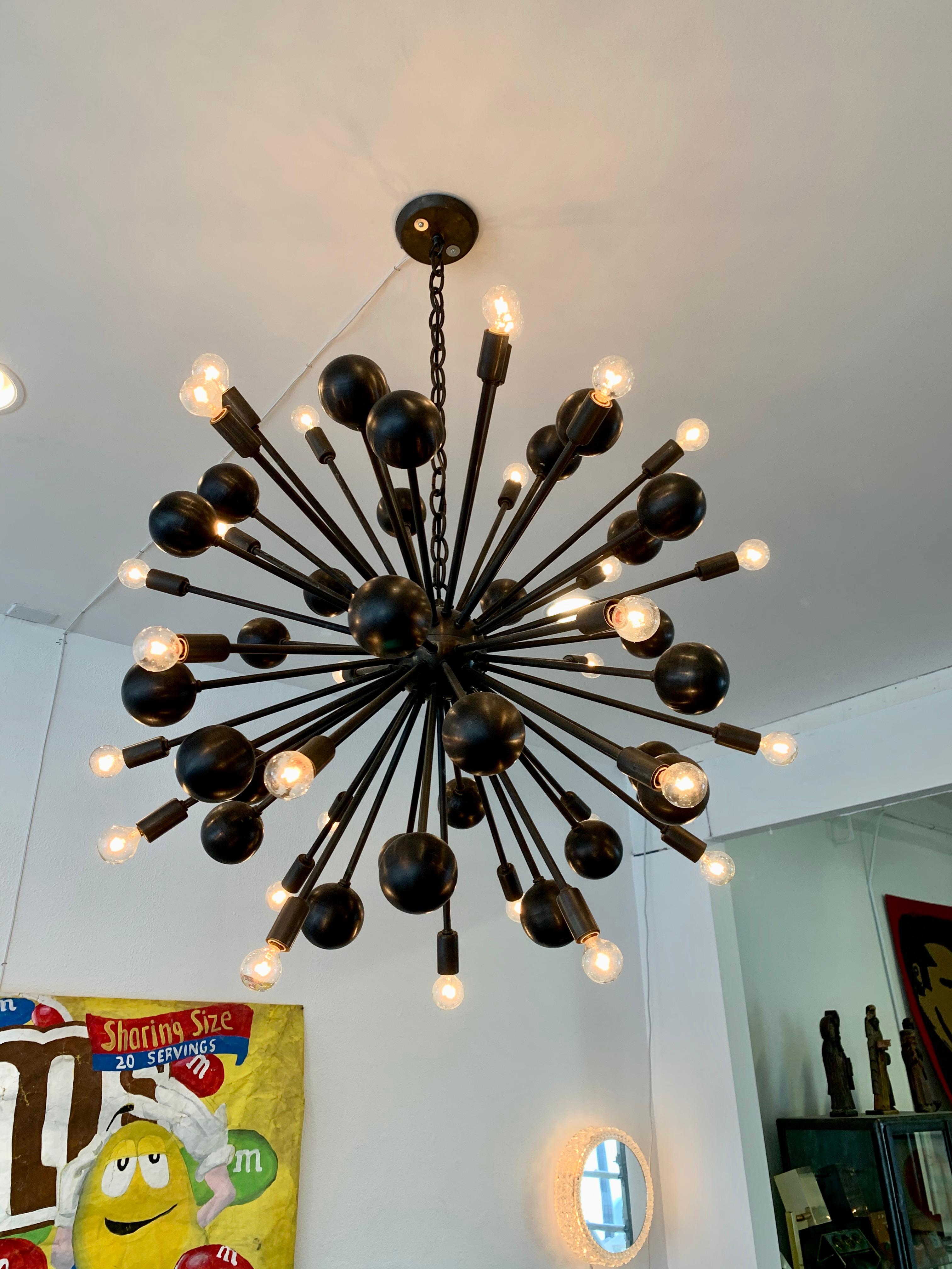 Giant Sputnik chandelier with 60 arms radiating from a central orb. Finished in oil rubbed bronze. 30 arms with lights and 30 arms with metal balls. Fixture is 36