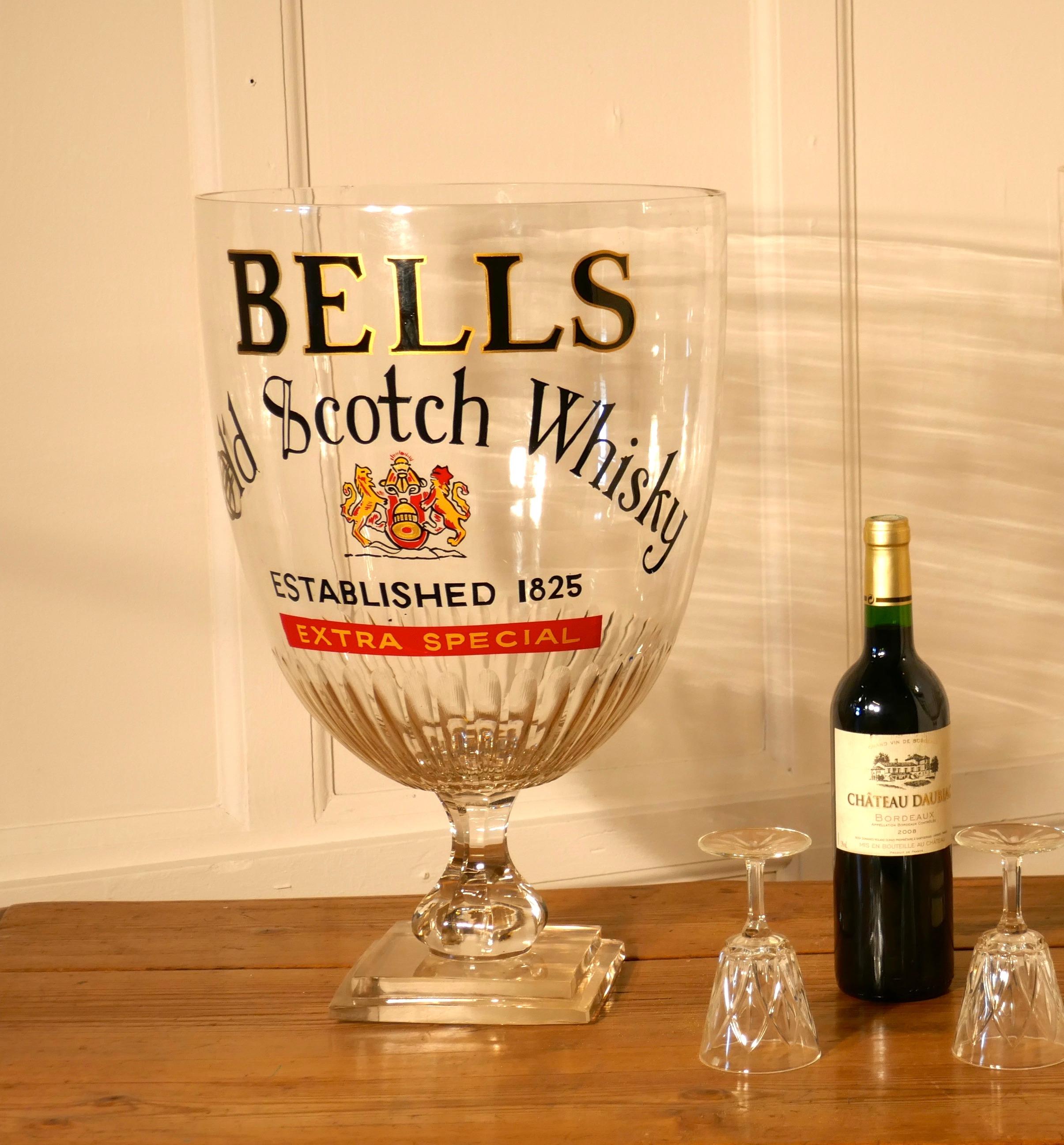 Giant Advertising Presentation Glass Chalice for Bells Scotch Whisky


This is an oversized Glass, made for Pub or Bar display advertising. 
The glass stands on a thick stepped square base, it has a fluted bowl and is 20” high
It is advertising