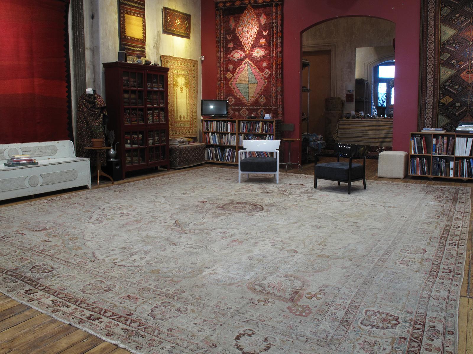 A great antique Indian carpet, showing the signs of its former life in the English countryside, still looking fabulous after all those years ...
Note: The upper right corner is slightly less worn and therefore appears darker.