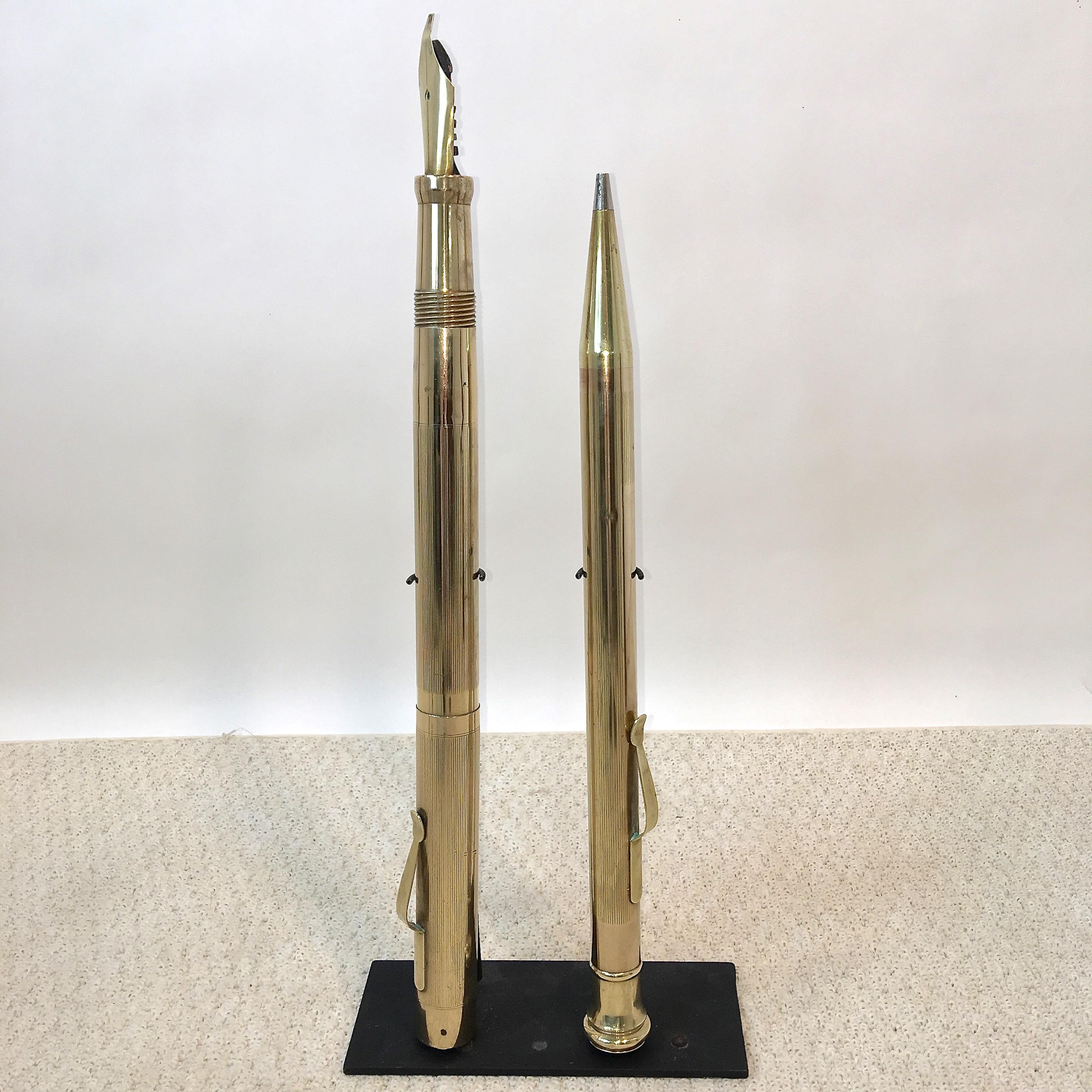 Oversized retail advertising presentation brass fountain pen and mechanical pencil display signs from the early 1920s when they would have been featured within a wood and glass display cabinet at the pen counter of a stationary store. 

Originally