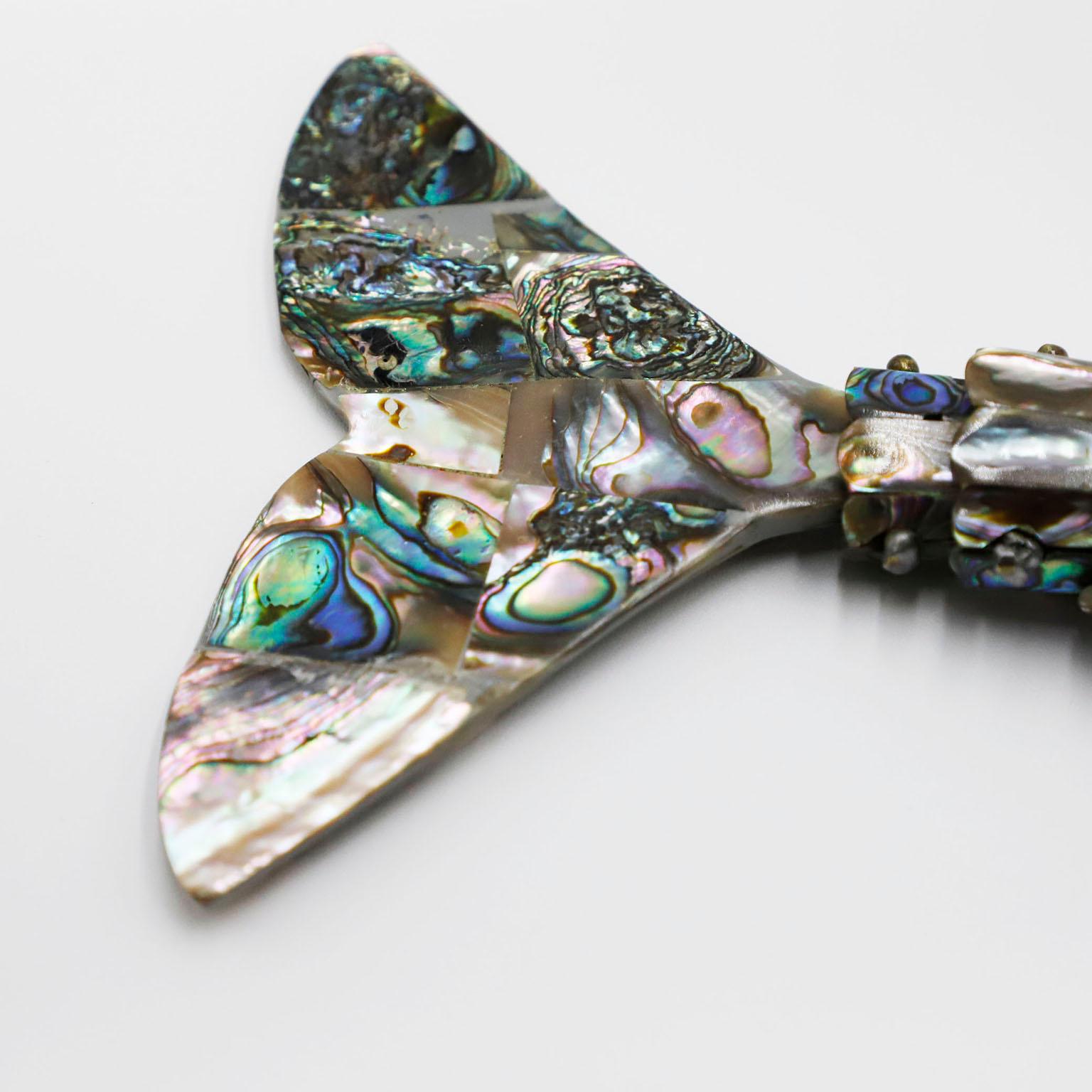 Beautiful vintage Mexican abalone shell and brass bottle opener in the form of fish by Los Castillo.
The mouth of the fish are made of brass which has a very nice aged patina. Made in Taxco Mexico, circa 1960s, stamped by Los Castillo.