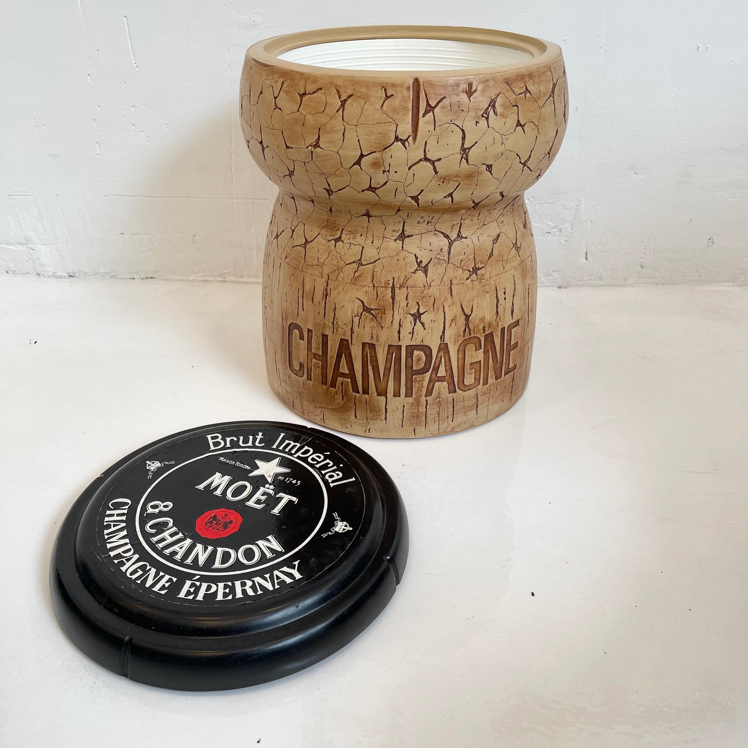 Whimsical champagne bucket/cooler by Think Big. Made in New York City, 1987. Stamped on underside. In the shape of champagne cork by Moet & Chandon. Made of plastic and rubber. Inside of cooler has plastic bucket to hold water/ice. Great
