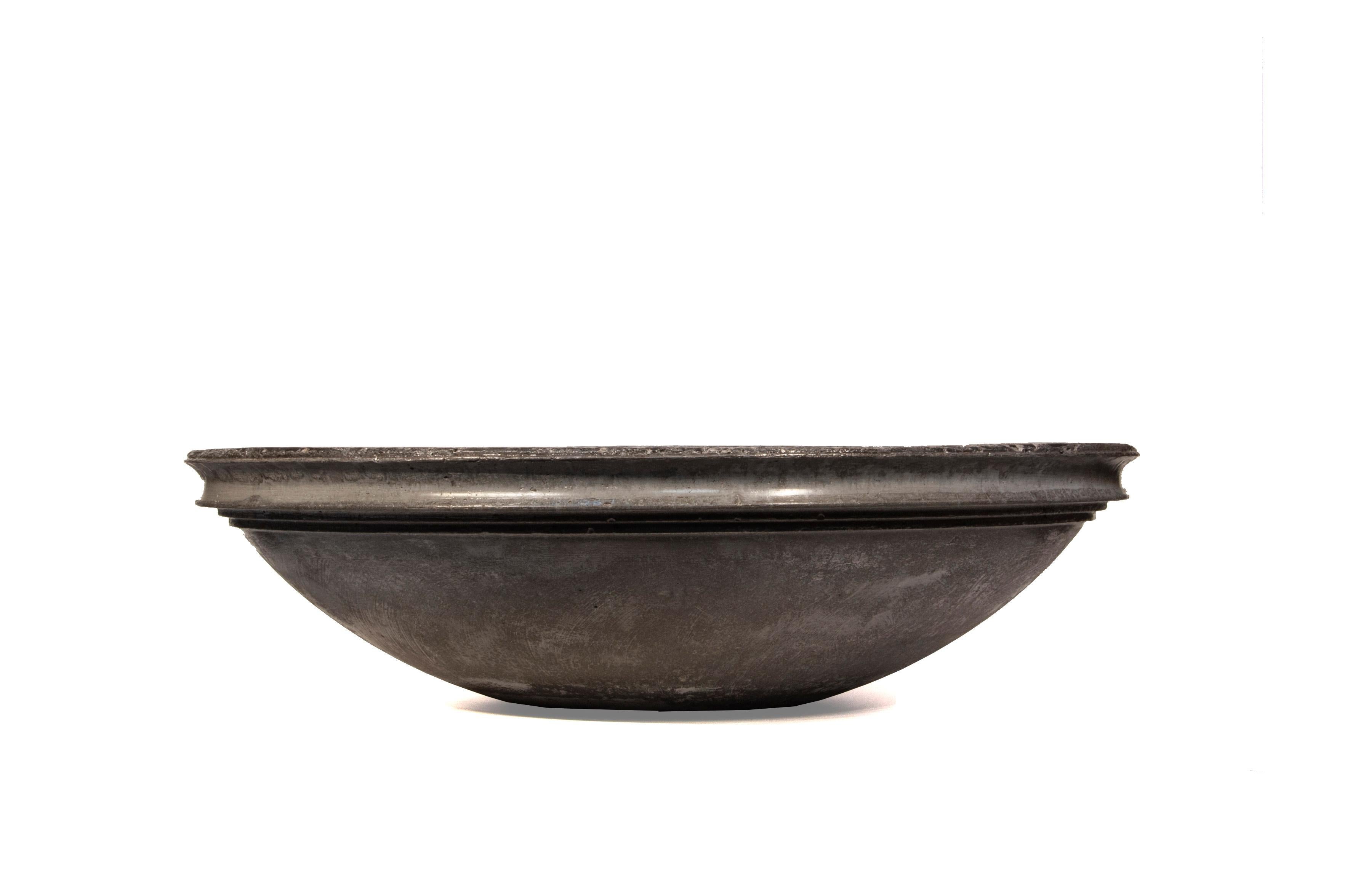 This bowl was made using charcoal and ash from the artist's property in northern California. Every year, fuel reduction in the forest provides fuel for heating his old cabin. The ash is then mixed with concrete, creating a timeless