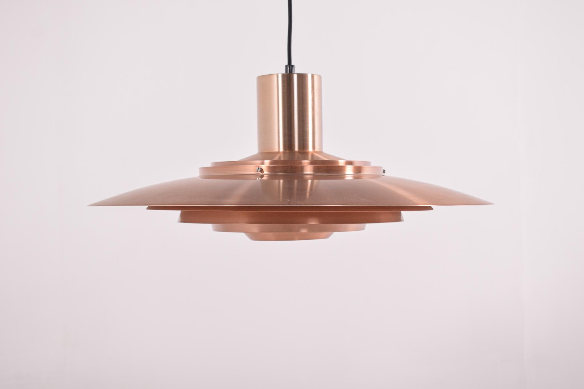 Copper ceiling lamp by Preben Fabricius & Jørgen Kastholm for Nordisk Solar, 1950s. Majestic floating from the ceiling does this elegant and rare P700 copper ceiling light. Designed for the large dining table or conference table, made from the best