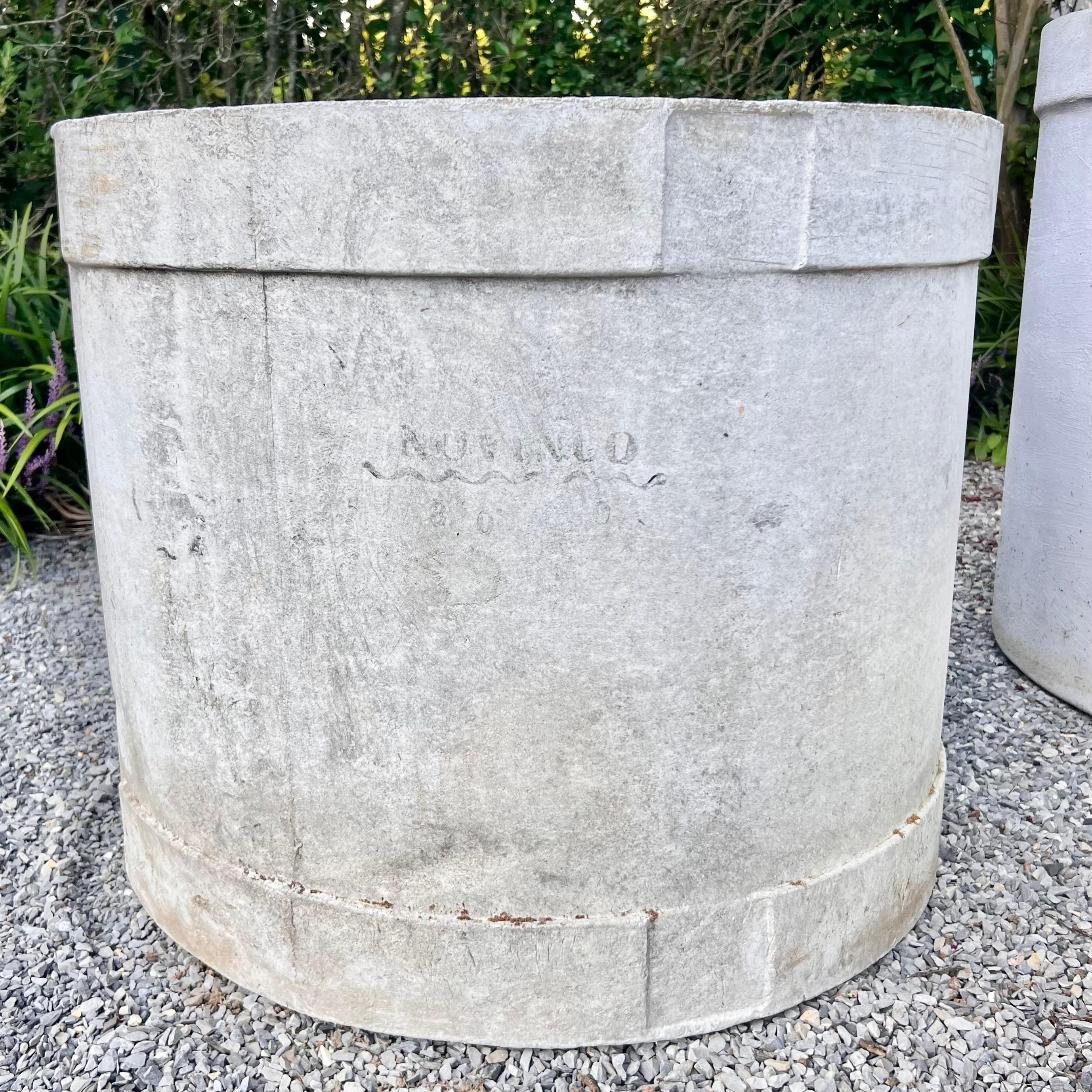 Giant concrete drum planter by Swiss architect Willy Guhl for Eternit. This substantial cylindrical concrete planter is a wonderful and functional piece for your home or garden. Age has given this planter a subtle and beautiful patina. Comes in a