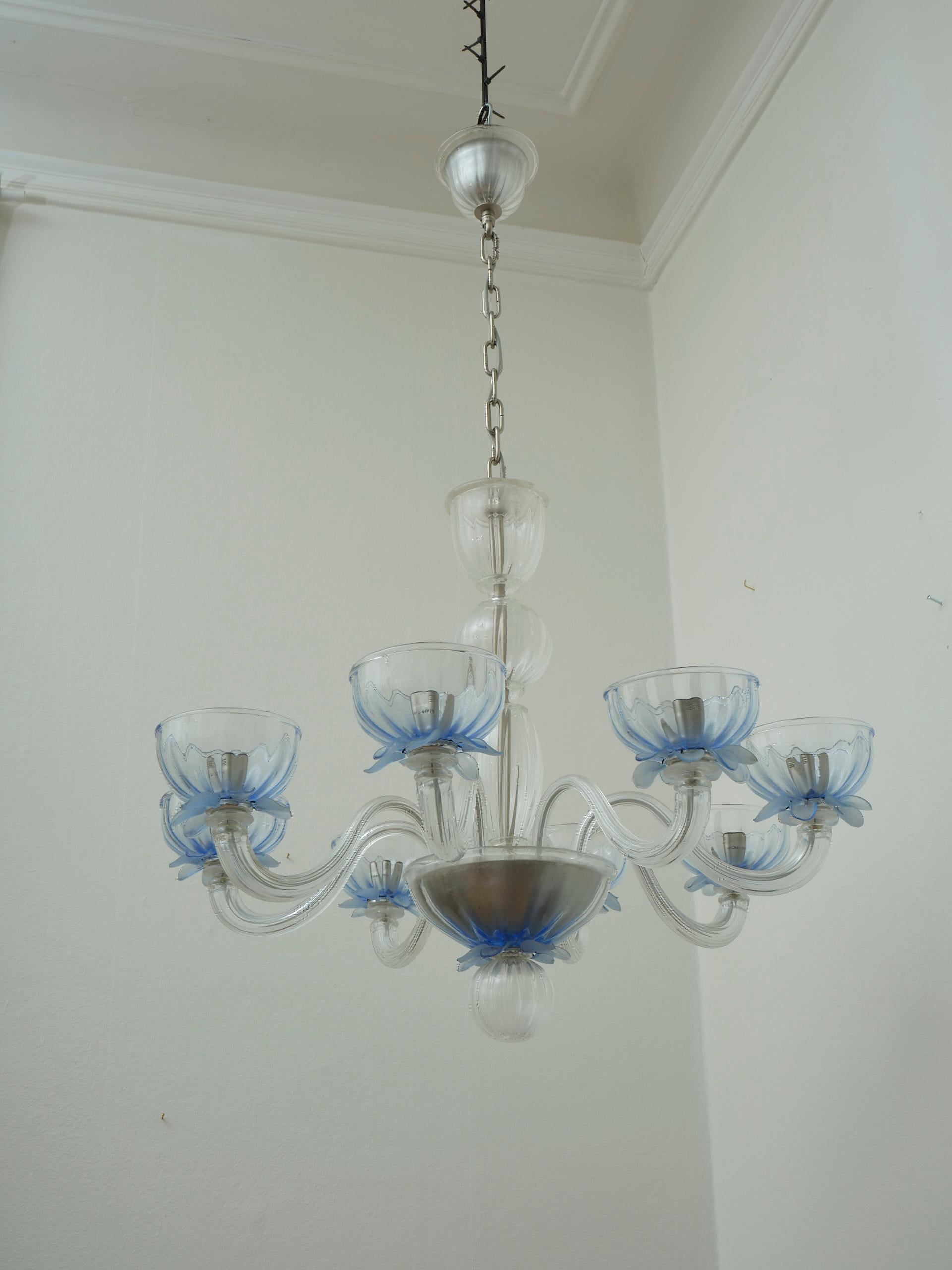Giant vintage European glass chandelier 8 arms blue details in the style of Murano. Creator unknown, but in the style of Murano and Organic Modern. Really decorative in clear glass with 8 arms and petal details in frosted and clear blue. 

This