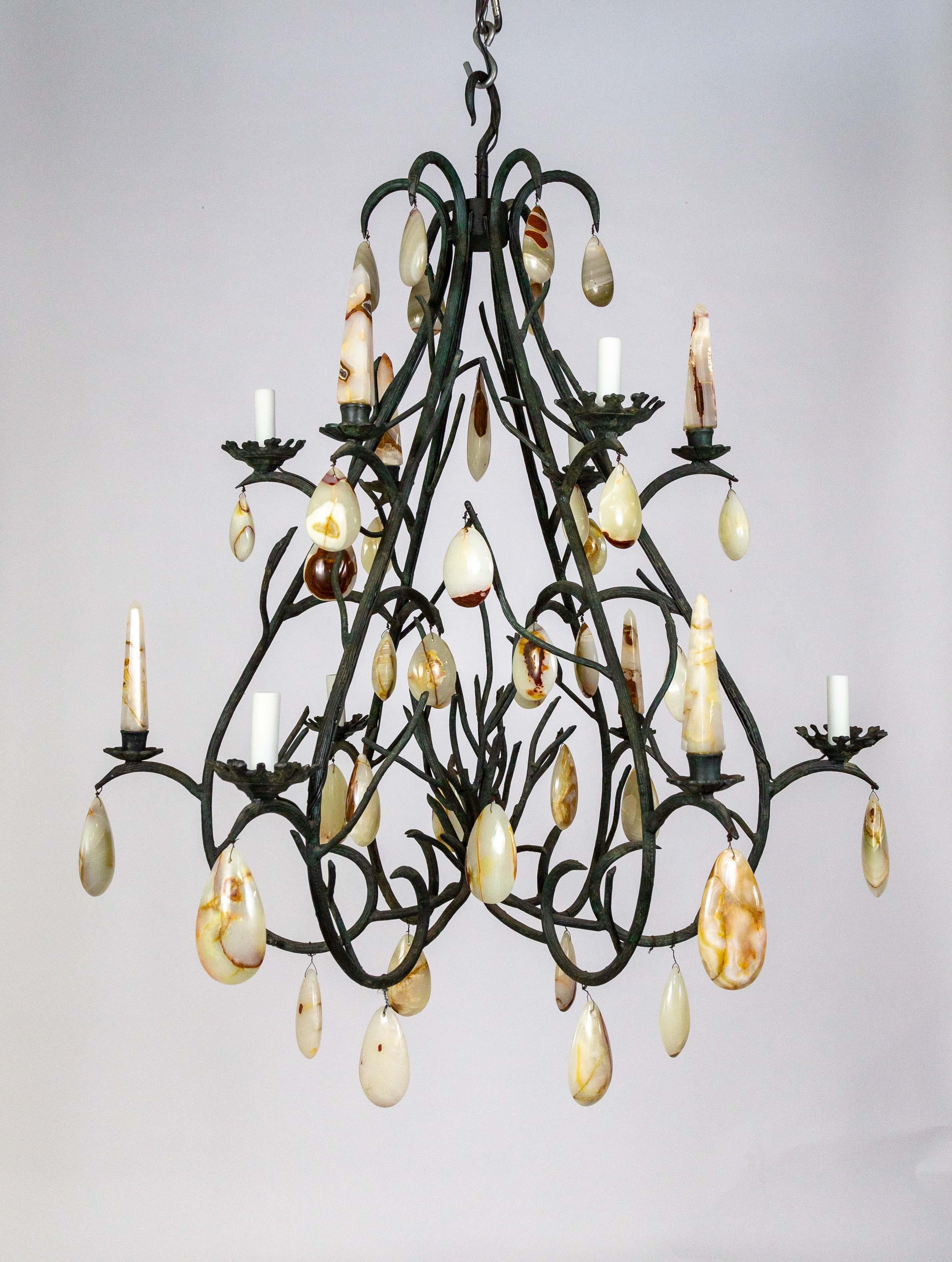 A sizable chandelier of curling branches in the form of an upside-down heart with two tiers of stone spears and 6 lights.  Designed by Luciano Tempo and made of reeded cast iron with forest-green finish and detailed bobeches The structure is decked