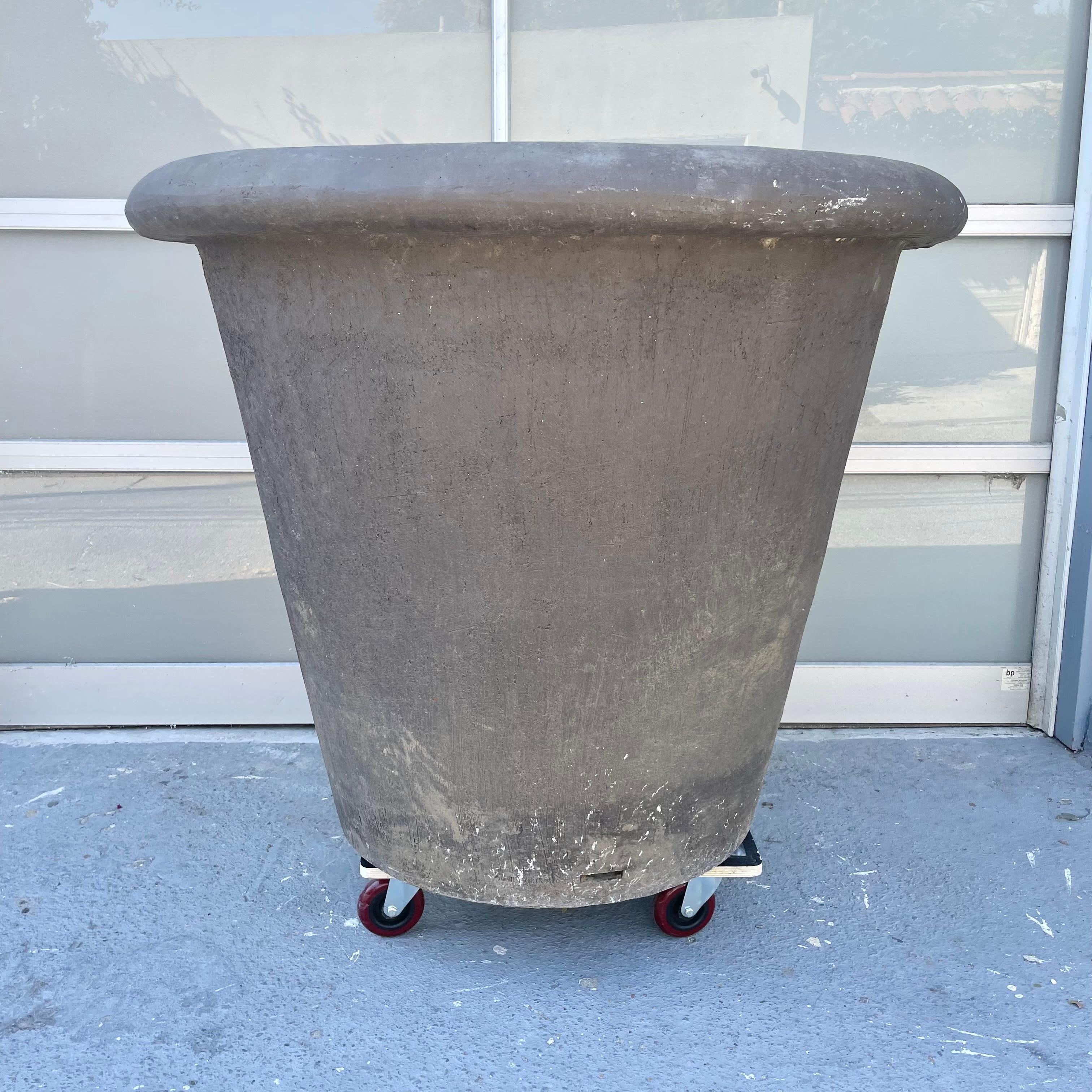 Monumental French terracotta planters in a charcoal grey finish. Just under 4 feet in diameter. Tapered down to the base giving it a classic and pronounced conical shape. Extremely pronounced and substantial rim around the top of the planter as well