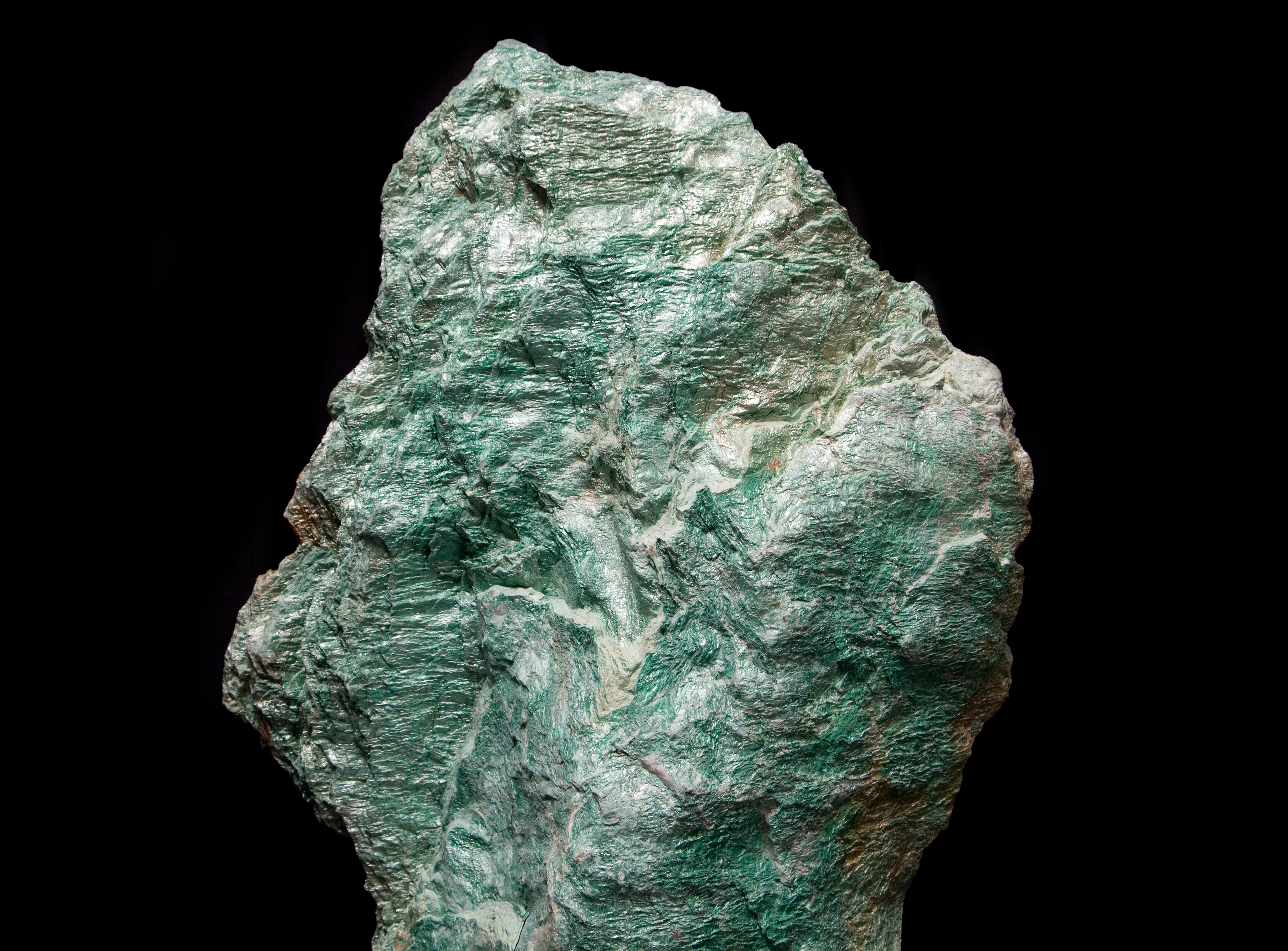 Giant Green Fuchsite mineral from Madagascar mounted onto a circular black steel base.