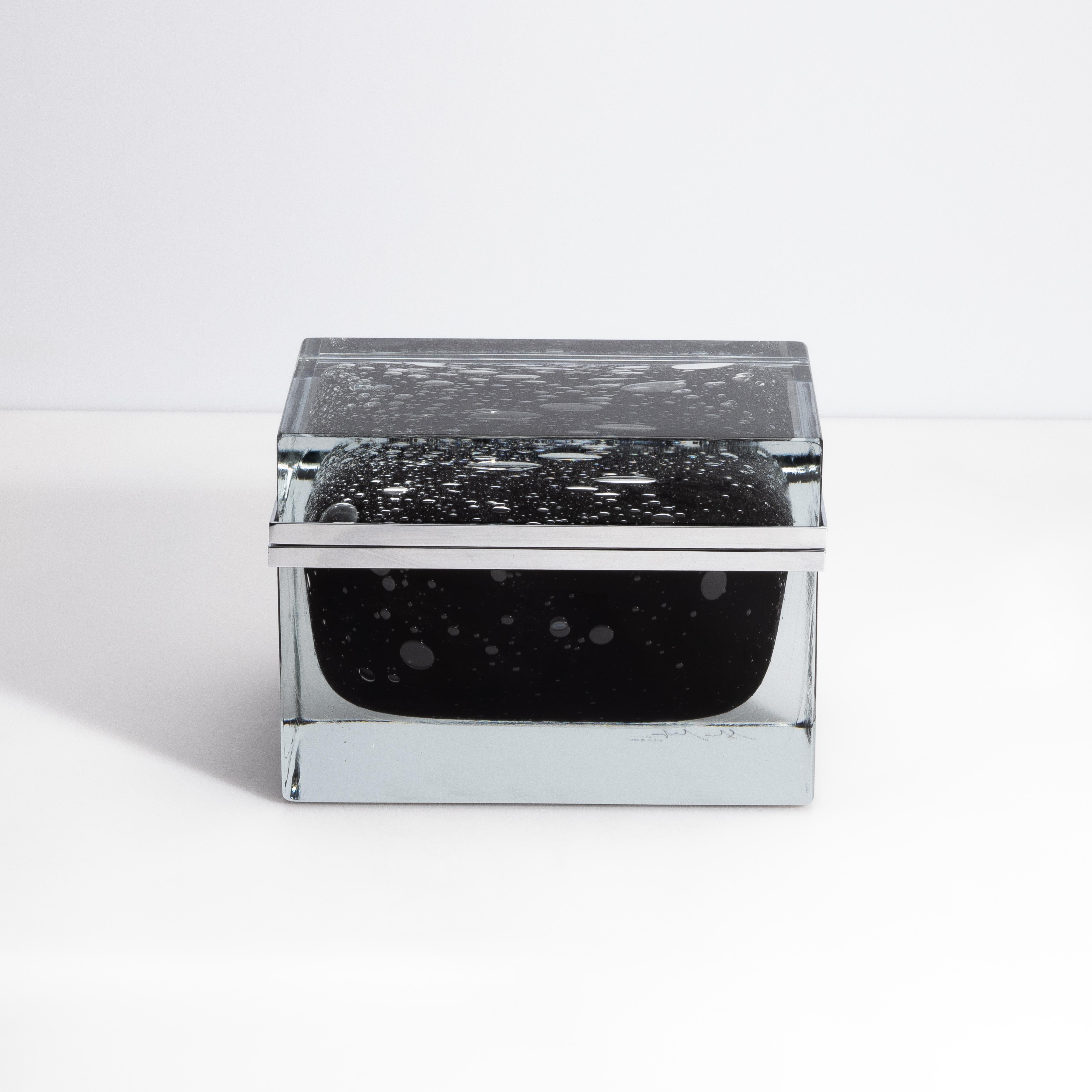 Impressive in its scale alone, this stunning hand-blown Murano glass box exudes luxury and refinement. This Pulegoso Murano glass box is a captivating fusion of artistry and functionality, crafted on the renowned Venetian Island of Murano.
