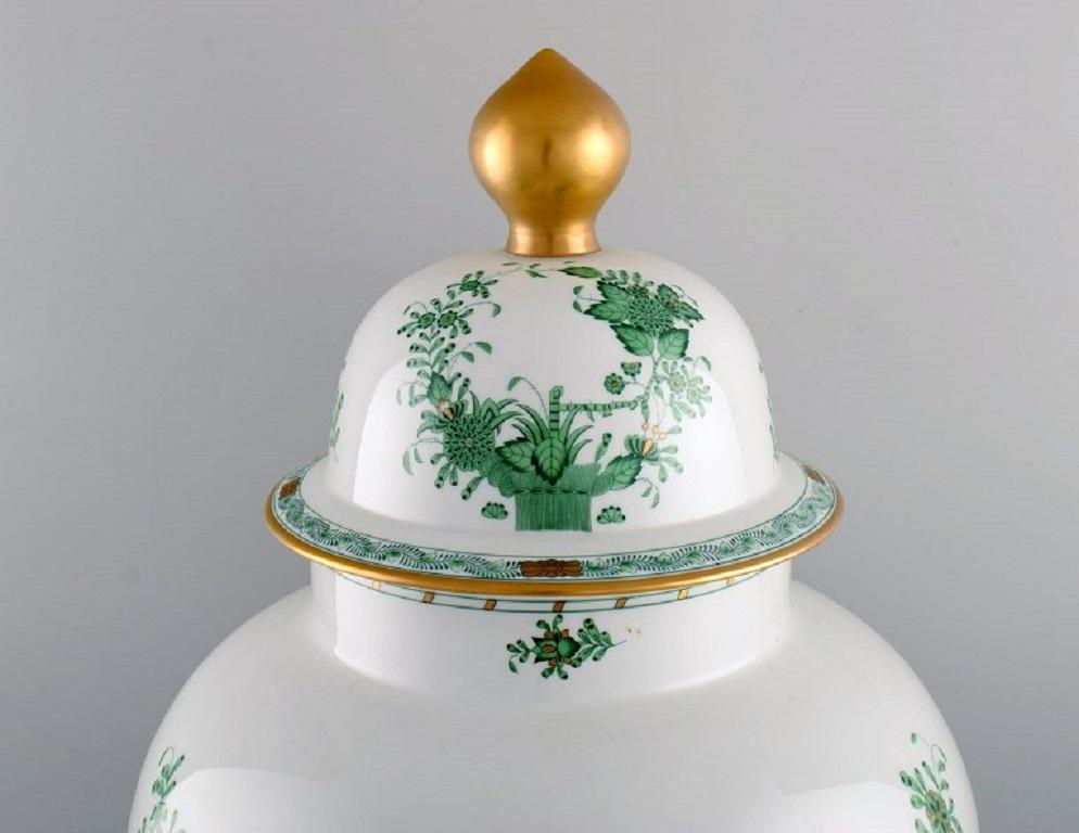 Riesige Herend Chinese Bouquet Deckelvase aus Porzellan mit handgemalten grünen Blumen und Golddekor. 
Mitte des 20. Jahrhunderts.
Maße: 58 x 33 cm
In ausgezeichnetem Zustand.
Gestempelt.