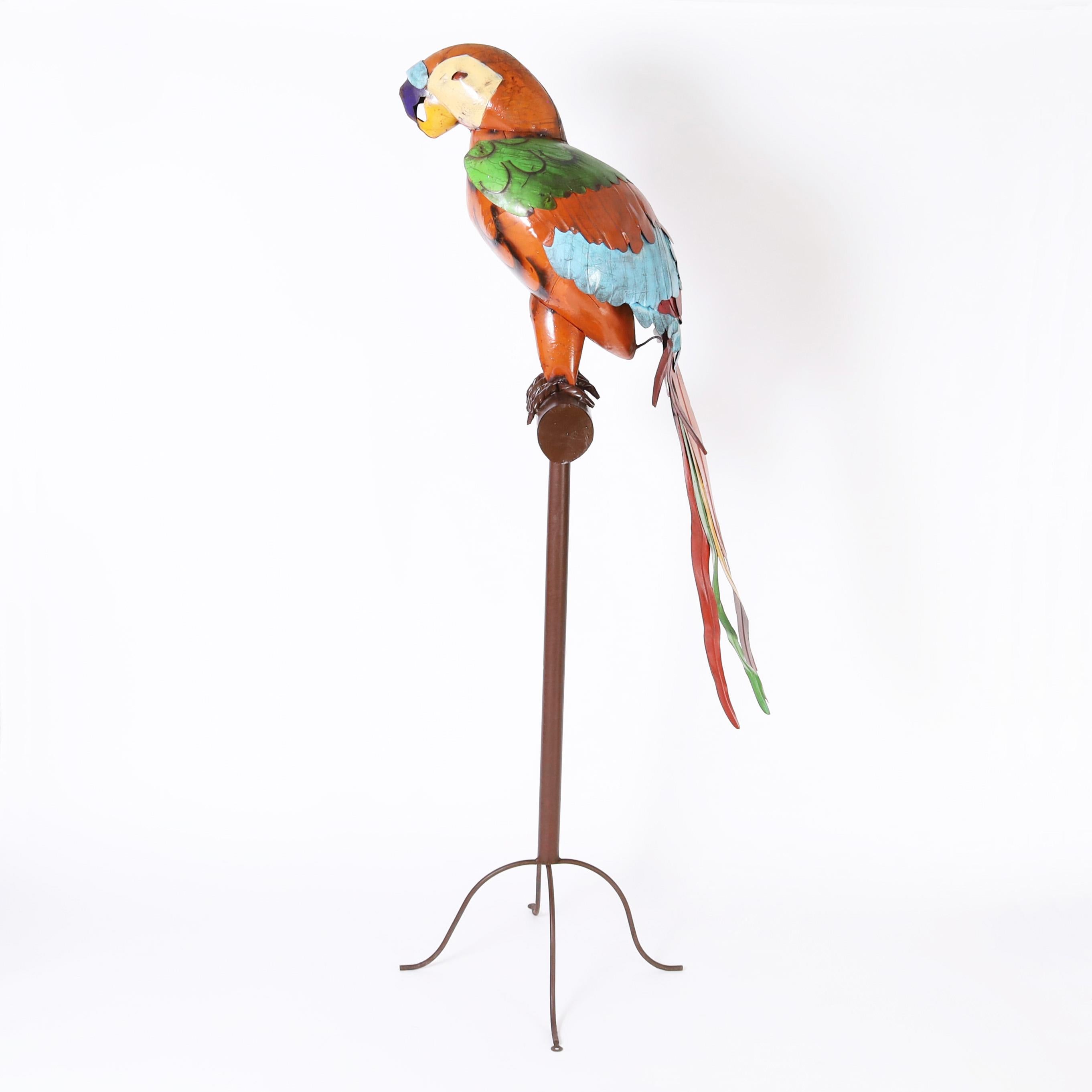 Outrageous vintage giant parrot sculpture hand crafted in metal, paint decorated and permanently perched on a metal stand with four cabriole legs.