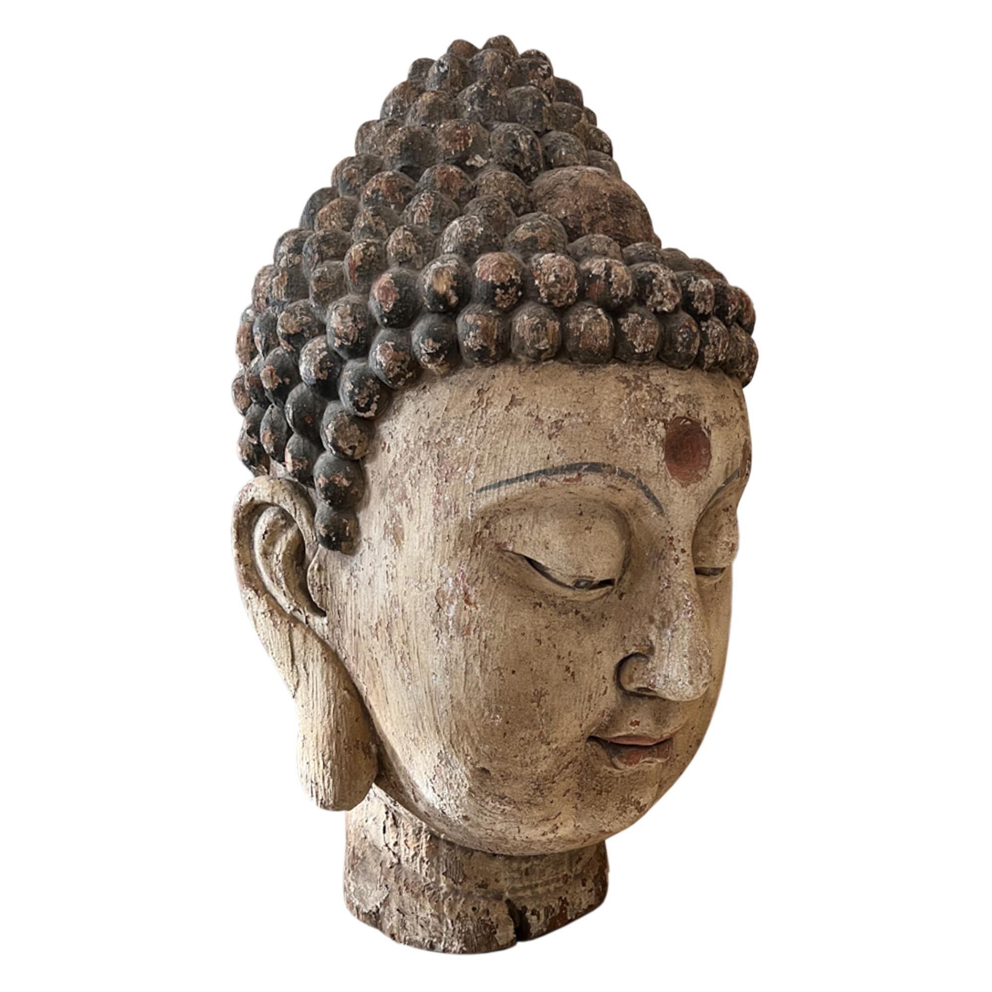 This grand scale wooden Buddha head was made in India in the 1950s. Take a look at all the pictures to see the details - especially on the eyebrows, lips and ears. The faded paint adds to it's charm.

A great decorative piece for your home, hotel or