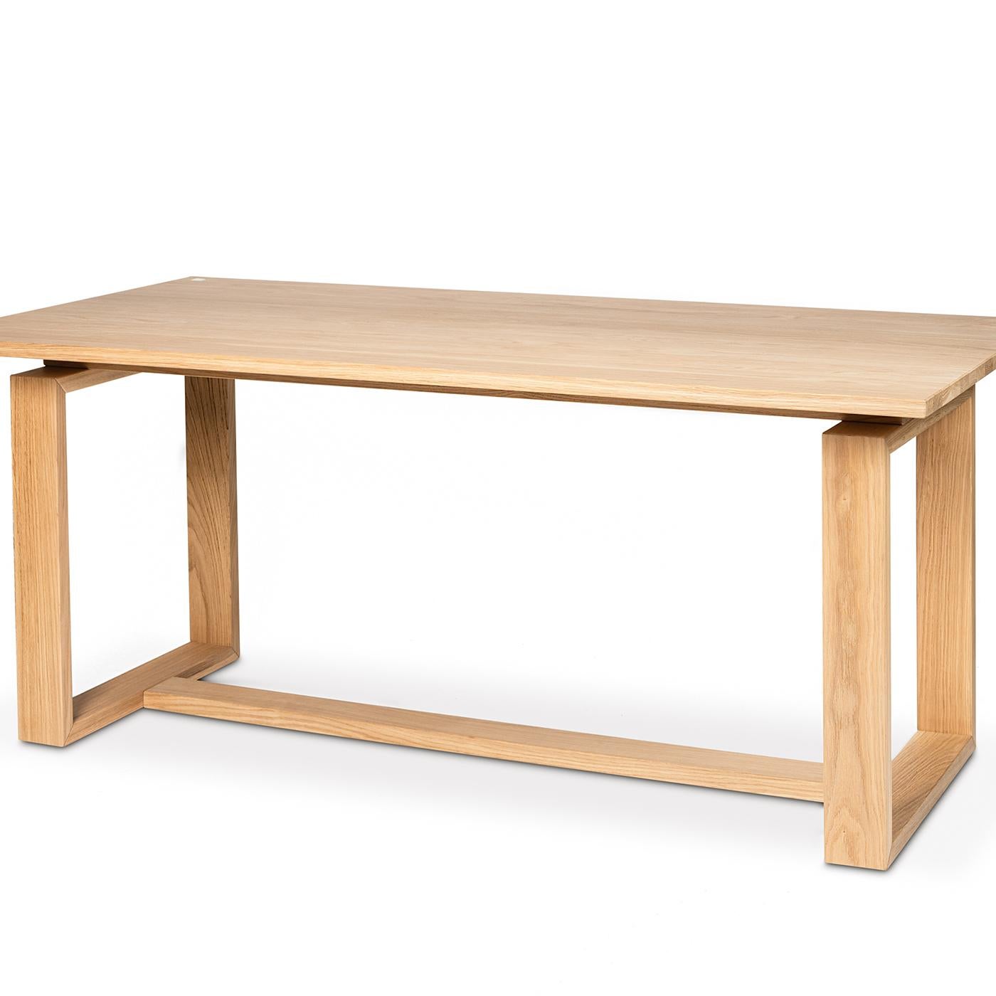 The structure of this gorgeous design table, with two window-like legs on either side and a connecting beam in the middle, is in solid oak that has been coated in a water-based varnish for clean and modern lines. A varnished wood laminate table top