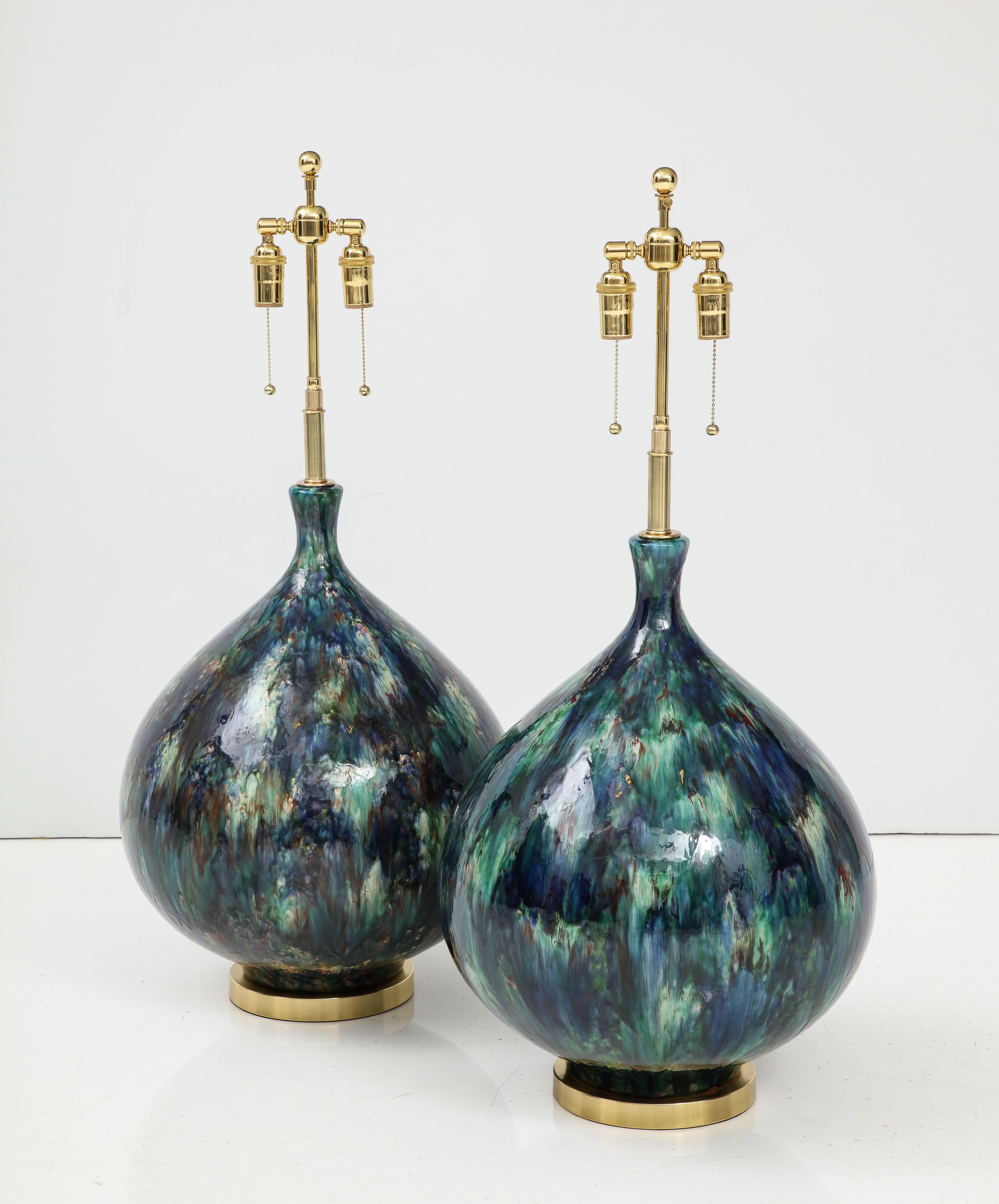 Giant pair of Italian ceramic lamps with a stunning glaze.
The lamps have been Newly rewired with adjustable  polished brass
double clusters that take standard size light bulbs.
The height to the top of the ceramic is 22