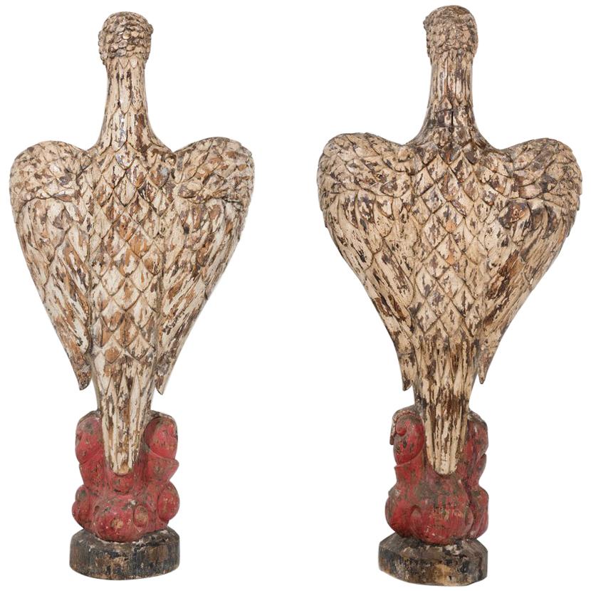 Monumental rare pair of carved wood eagles of 100 inches (2, 50m) height each.
Carved wood, formerly polychromed, base in stylized motives. 
Beautiful age patina. 
Absolutely spectacular.
Amazing and unexpected.
Dimensions:
96.46 in. H x 51.18