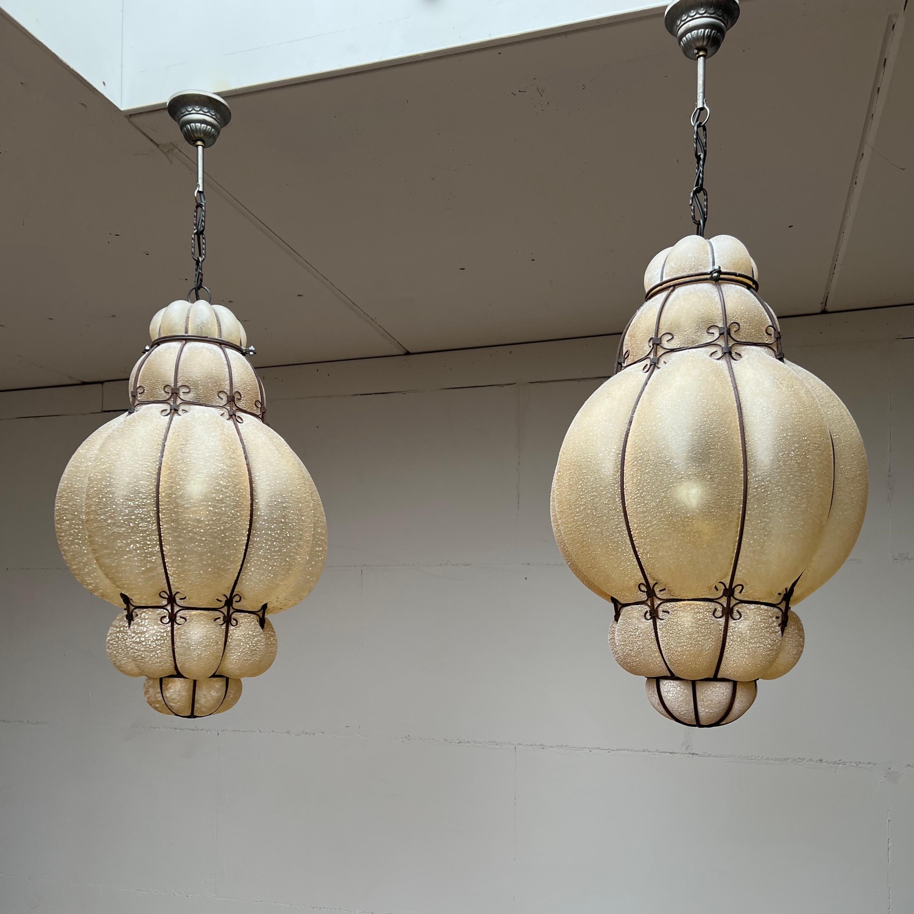 These large size & marvelous shape mouth blown pendants / chandeliers are in near-mint condition.

To give you a better idea of the unique size of this striking, frosted glass Murano pendant we have added image 3 where one is placed next to a very