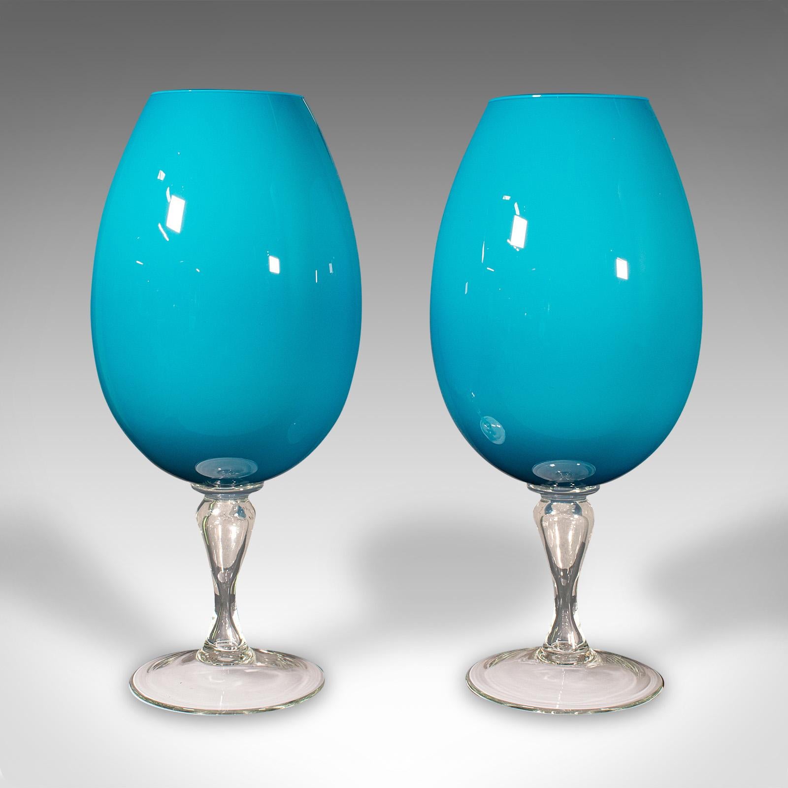This is a giant pair of vintage wine glasses. An English, decorative glass planter or vase, dating to the late 20th century, circa 1970.

Larger than life vases for the light-hearted wine lover
Displaying a desirable aged patina with one small flaw