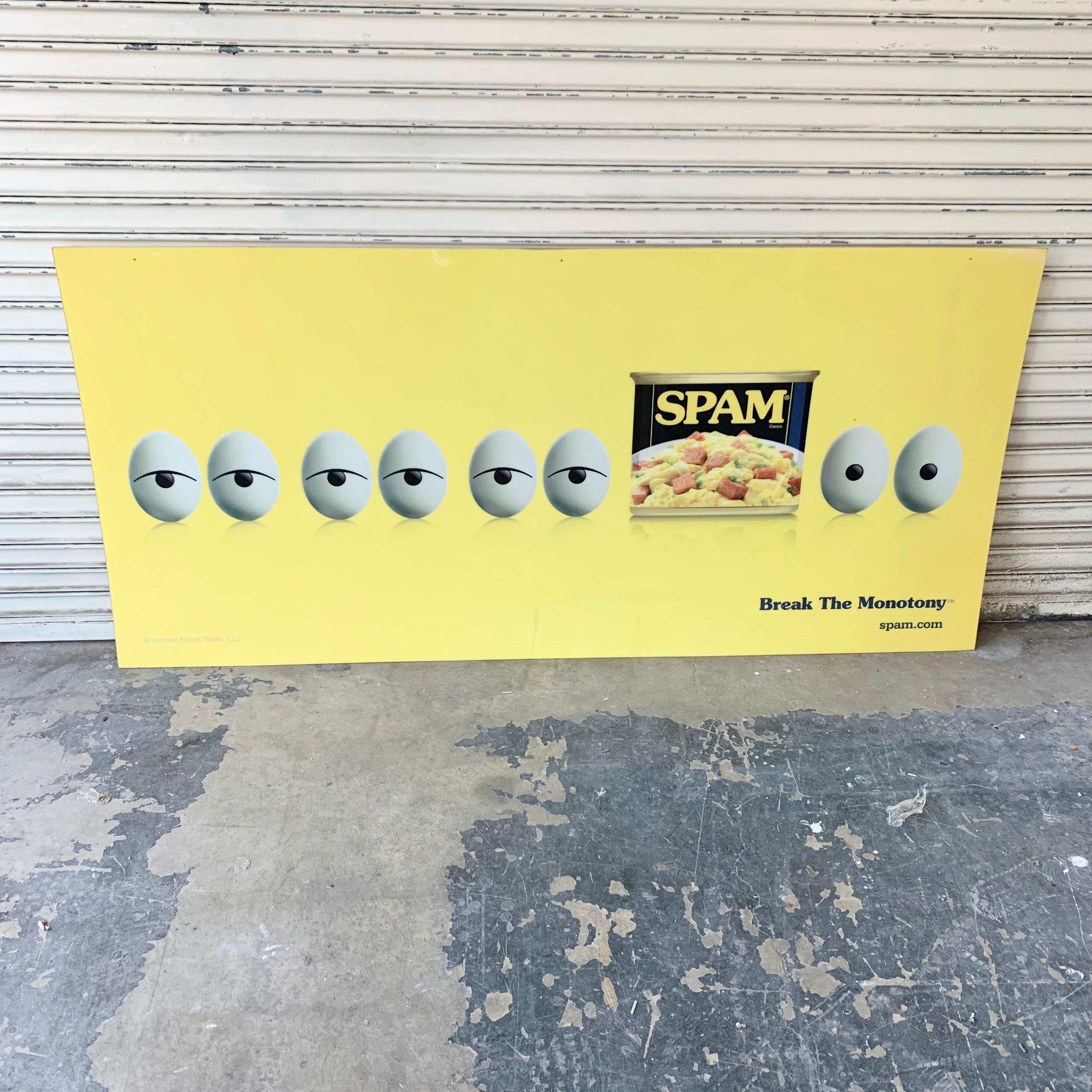 Massive advertising plastic board made by Hormel Foods LLC, makers of spam. Board is a canary yellow depicting a row of eyeballs (eggs) and then a can of SPAM. The tag line at the bottom says BREAK THE MONOTONY. Cool graphics, good condition. Size: