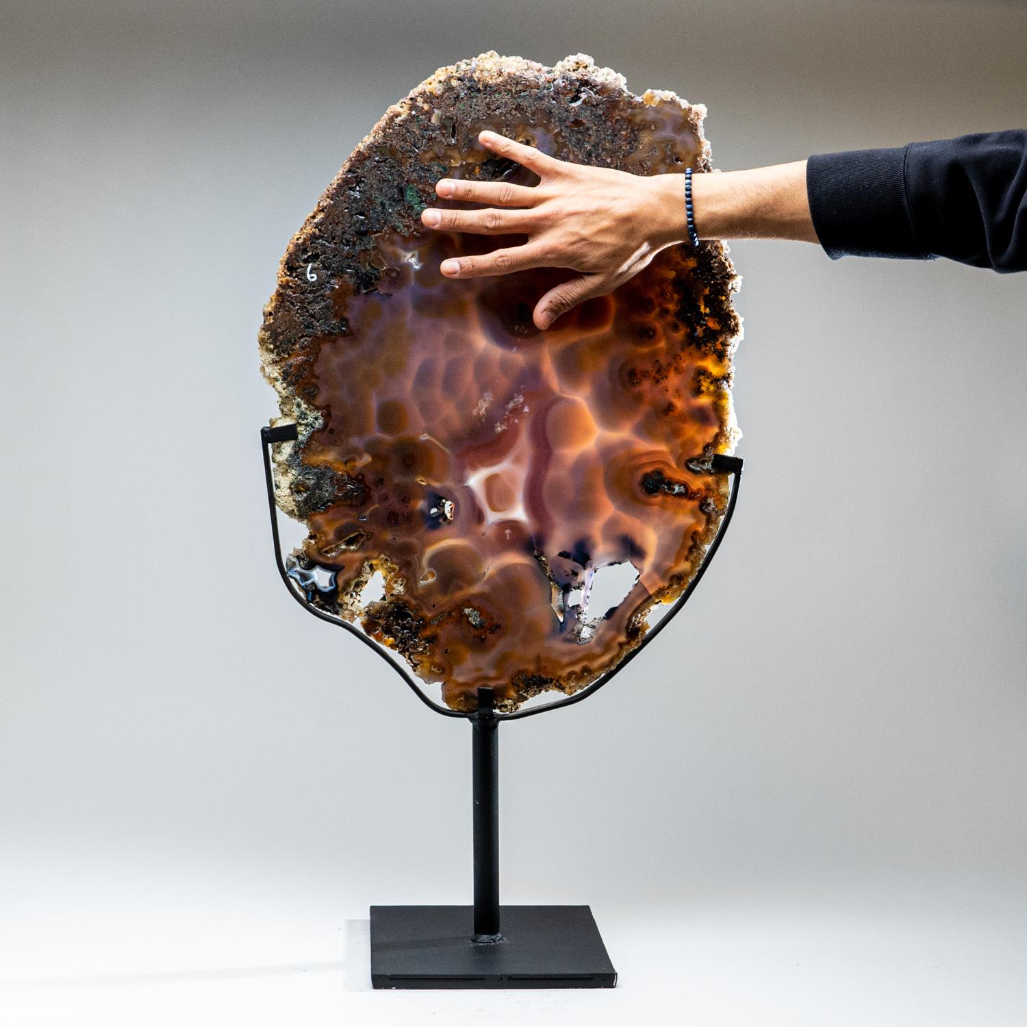 Beautiful, giant Brazilian banded agate mounted on a metal stand. Both sides are polished to a glassy finish revealing soft bands of beige and grey tones.
Agates are grounding stones, bringing about an emotional physical and intellectual balance.