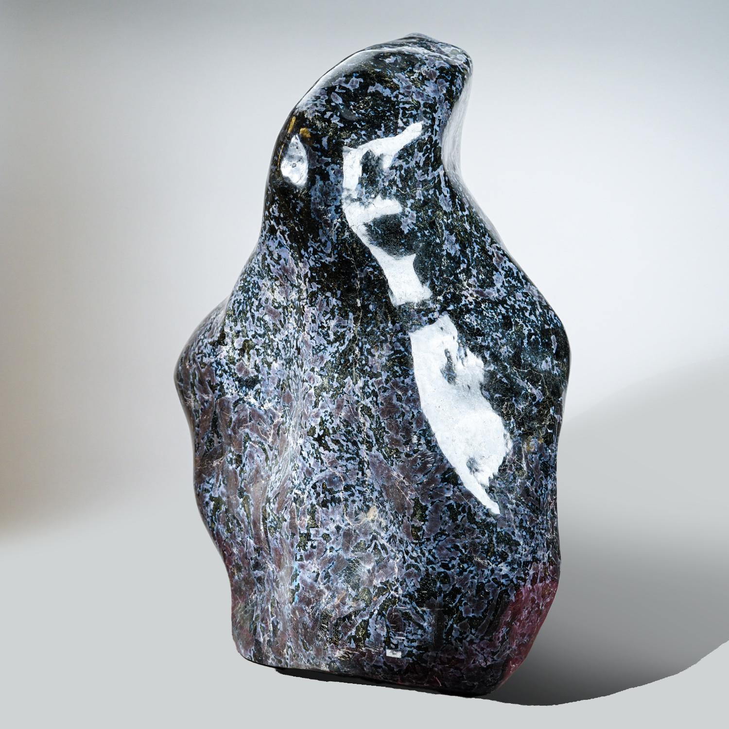 This extraordinary piece of solid, Mystic Merlinite, also known as Indigo Gabbro weighs approximately 300 lbs. It is composed of feldspar, quartz, igneous rock, and other minerals, creating an extremely unique pattern. Its modern shape and size