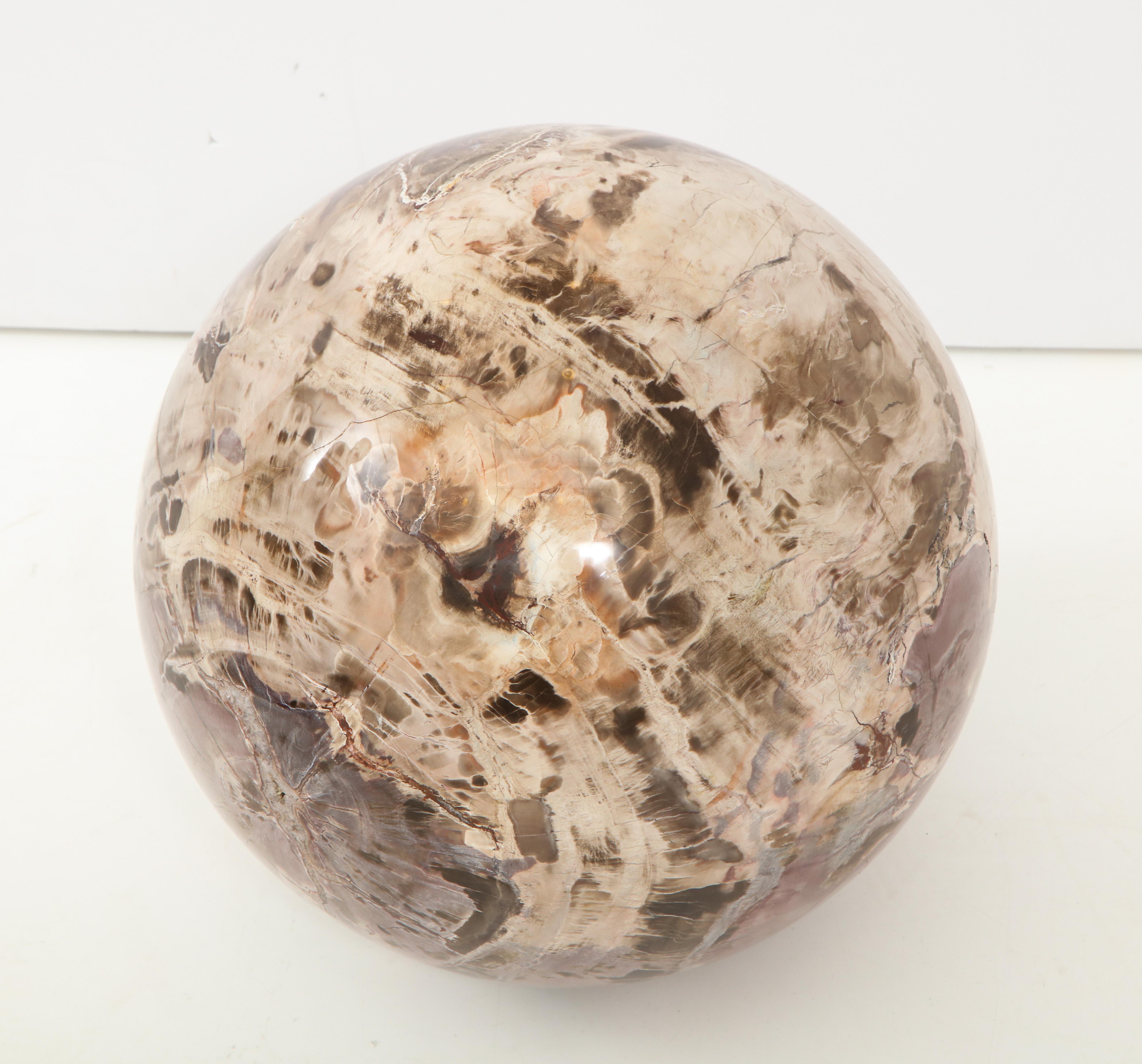 Spectacular polished petrified wood sphere.
The sphere sits on a separate polished 6