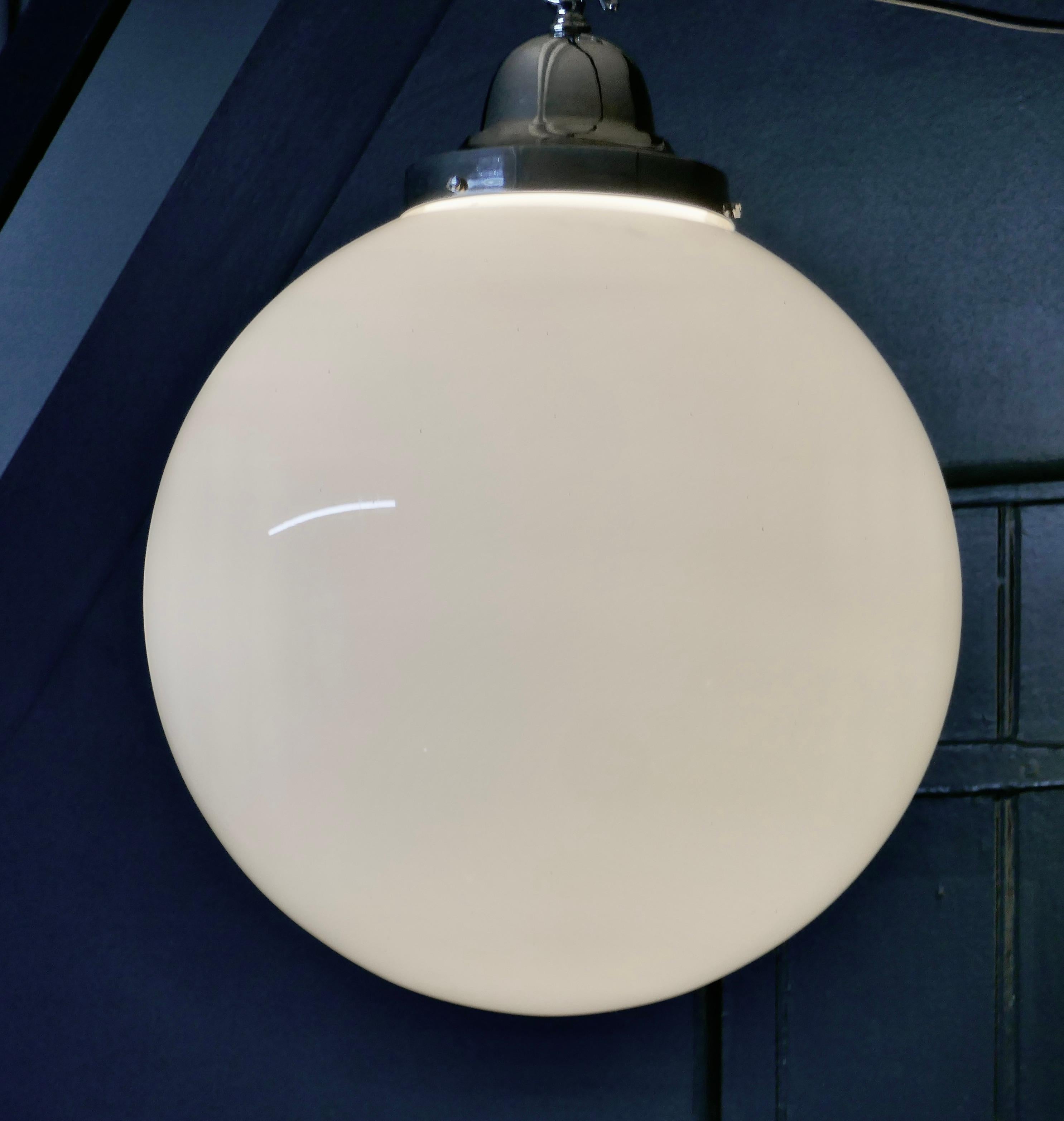 Giant Retro Glass Globe Hanging Light

We have 2 of these beautiful large lamps available, this listing is for 1 only 
Simple and beautiful, this very large globe has a chrome gallery with a hook for hanging
Both lights are in good all round