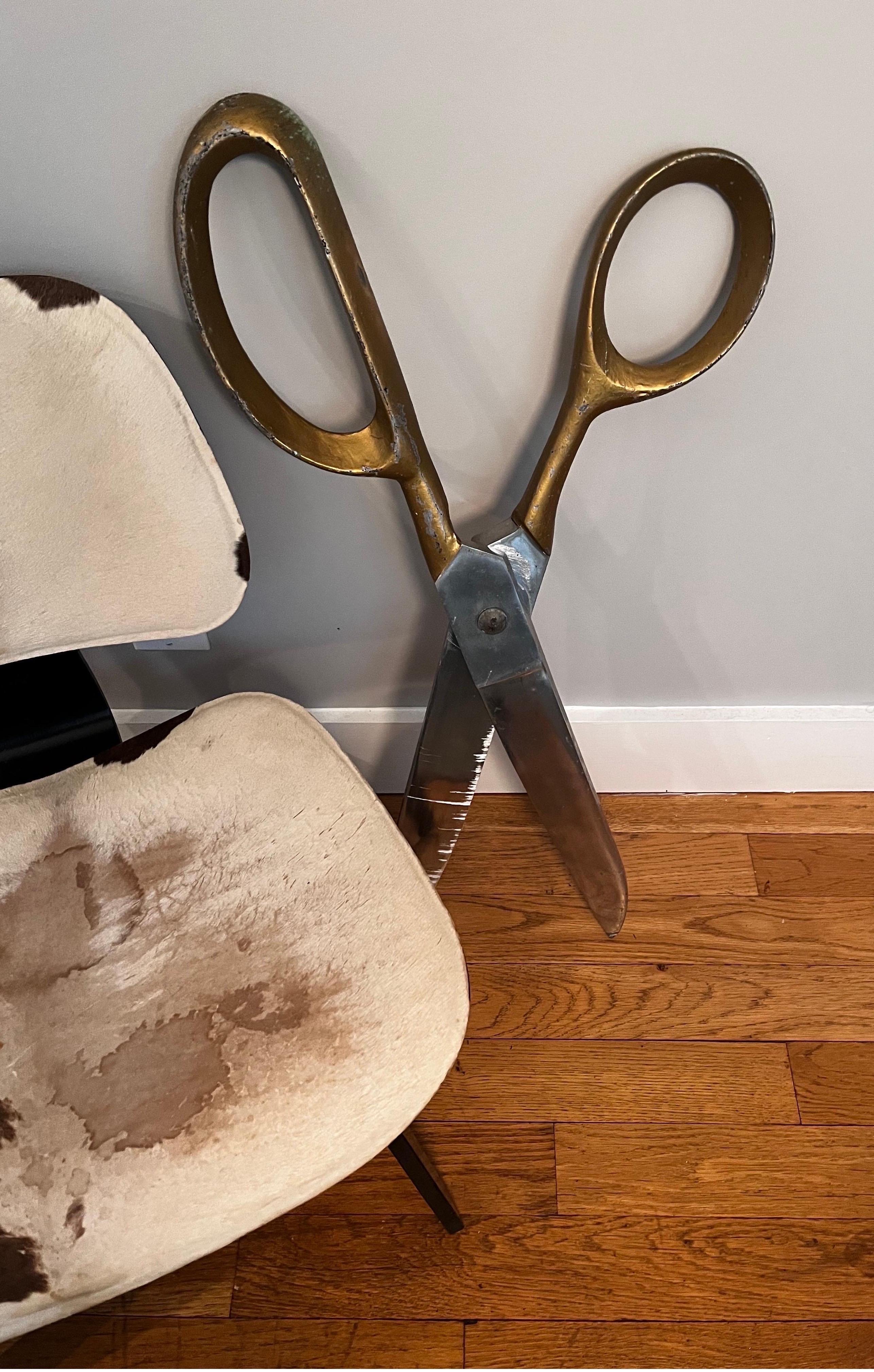 Cast aluminum oversized scissors 

probably used for advertising and or store display.
These will add interest to any room, wall, hair salon or fashion fashion boutique, etc.

In the style of Claes Oldenburg.